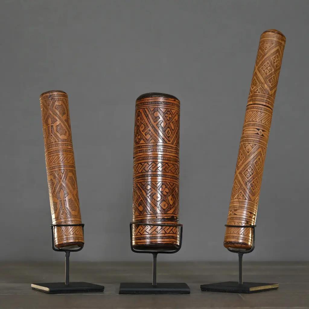 This set of three carved wooden ointment boxes originates from Timor, Indonesia. Traditionally used by local healers to store medicinal ointments and herbal remedies, these authentic objects reflect the spiritual and artisanal heritage of Timorese