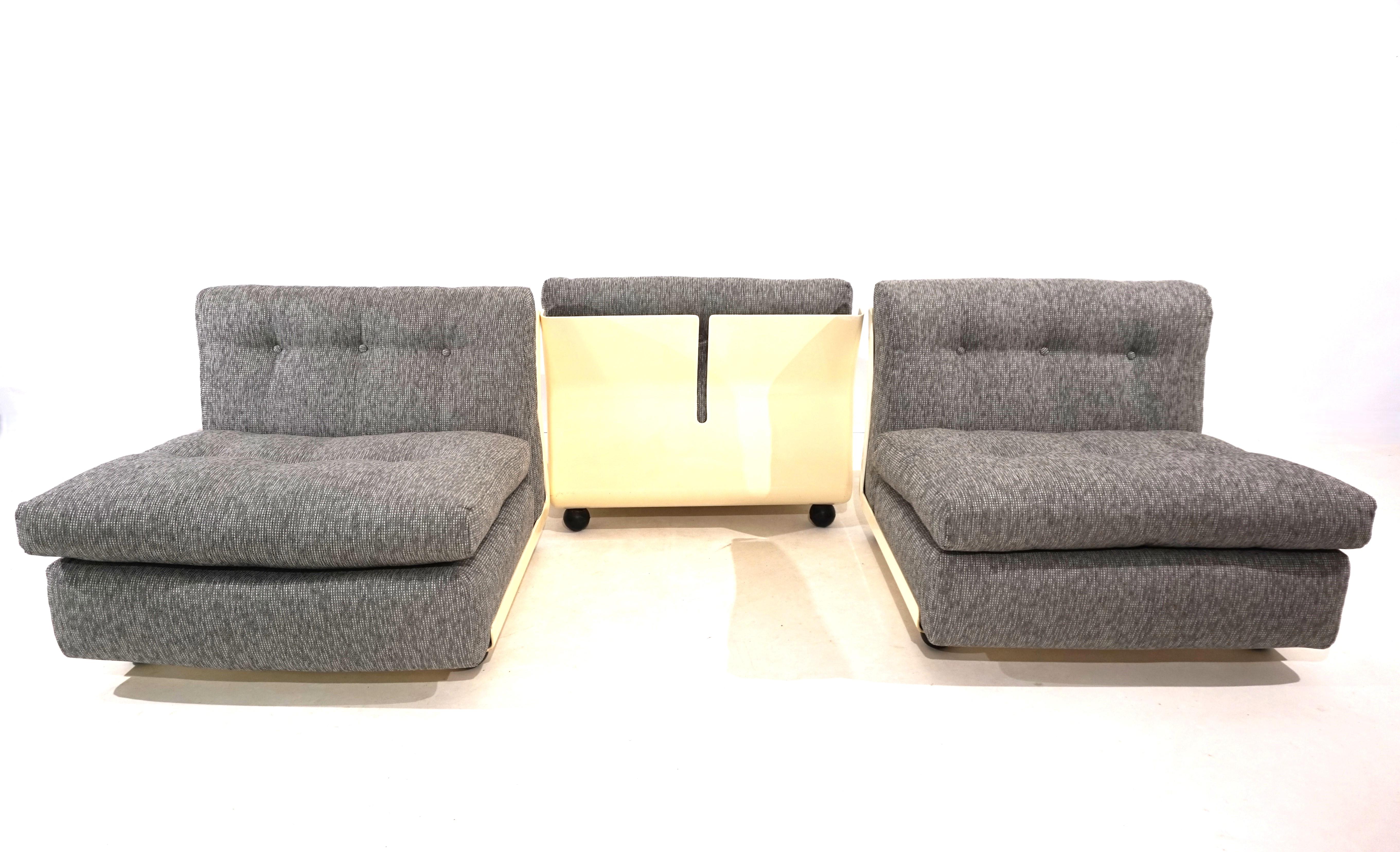 A set of three Amanta modular armchairs in a high-quality platinum/silver boucle fabric with light fiberglass shells. The armchairs have been newly upholstered and covered and offer first-class seating comfort. The back shells only show minimal