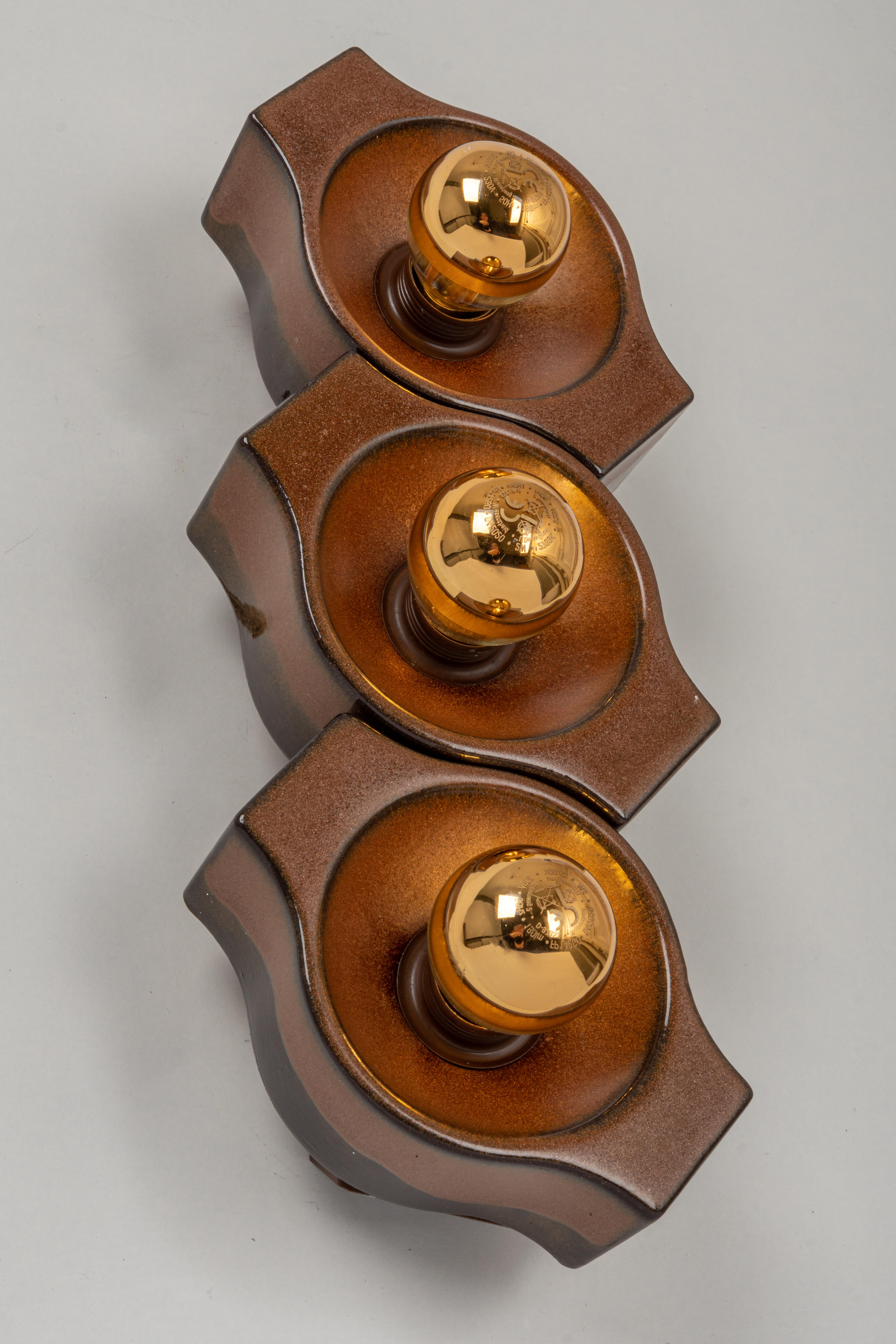 Set of 3 ceramic brown wall light Sputnik desiged by Cari Zalloni Germany, 1970s
Heavy quality and in very good condition. Cleaned, well-wired and ready to use. 
These wall lights can be only mounted as a set.

Each wall light requires 1 x E14