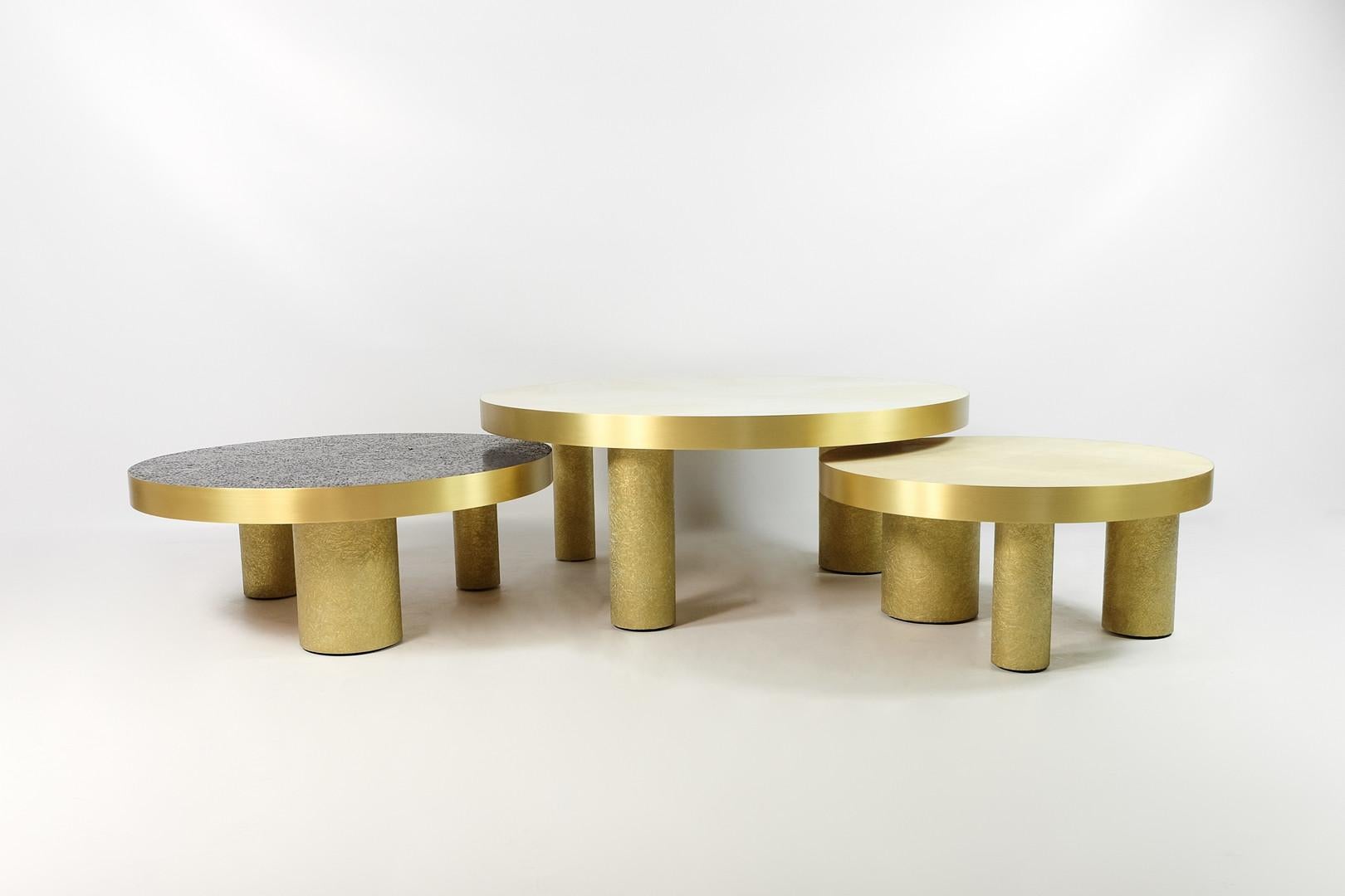This set of 3 coffee tables is made of various inlaid materials.
These modular tables can be setted up following your wishes.
The center piece is covered with a polished white rock crystal marquetry, the side tables are inlaid with natural