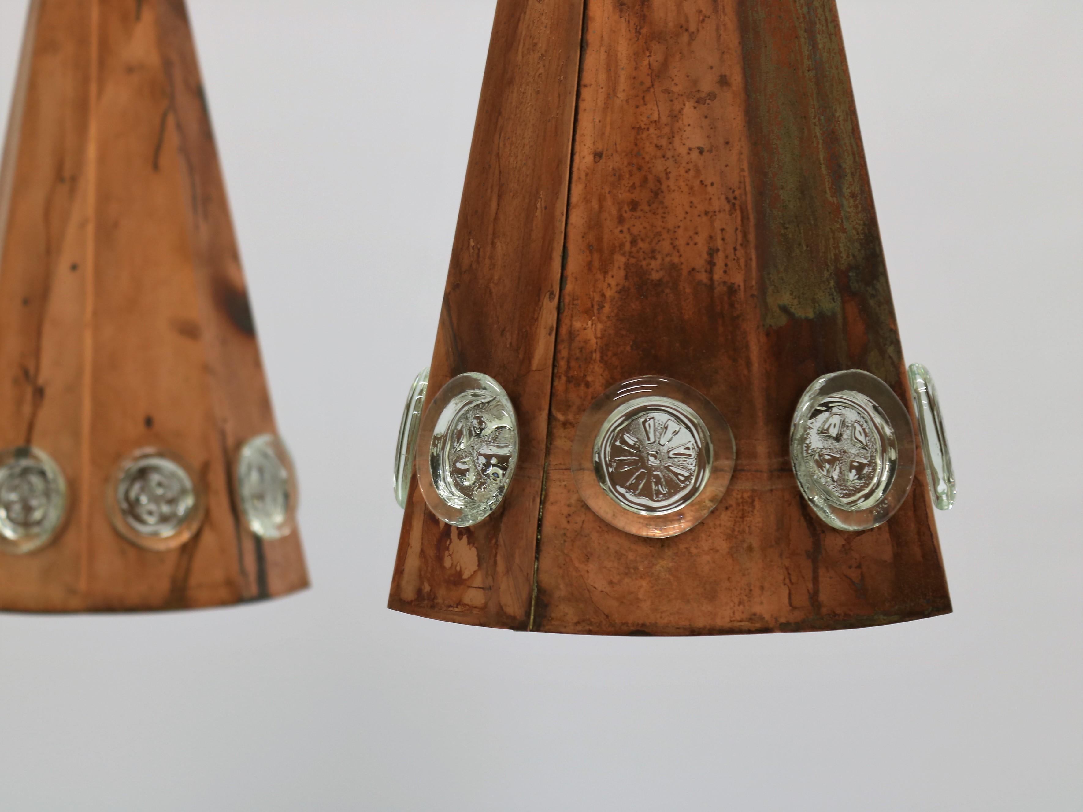 Set of 3 large conical shaped copper pendants with thick glass inserts made by Danish designer Svend Aage Holm Sorensen in the 1960s. Great example of Scandinavian modernism in the Brutalist style.