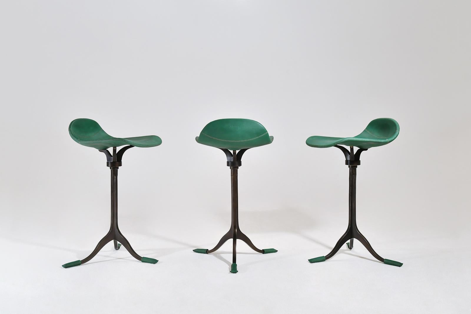Three counter stools, brass and leather, by P. Tendercool
 
These barstools in green leather and blackened-brown brass combo were commission by an Italian businessman for his loft in Bangkok.
Since these are made-to-order they are available in