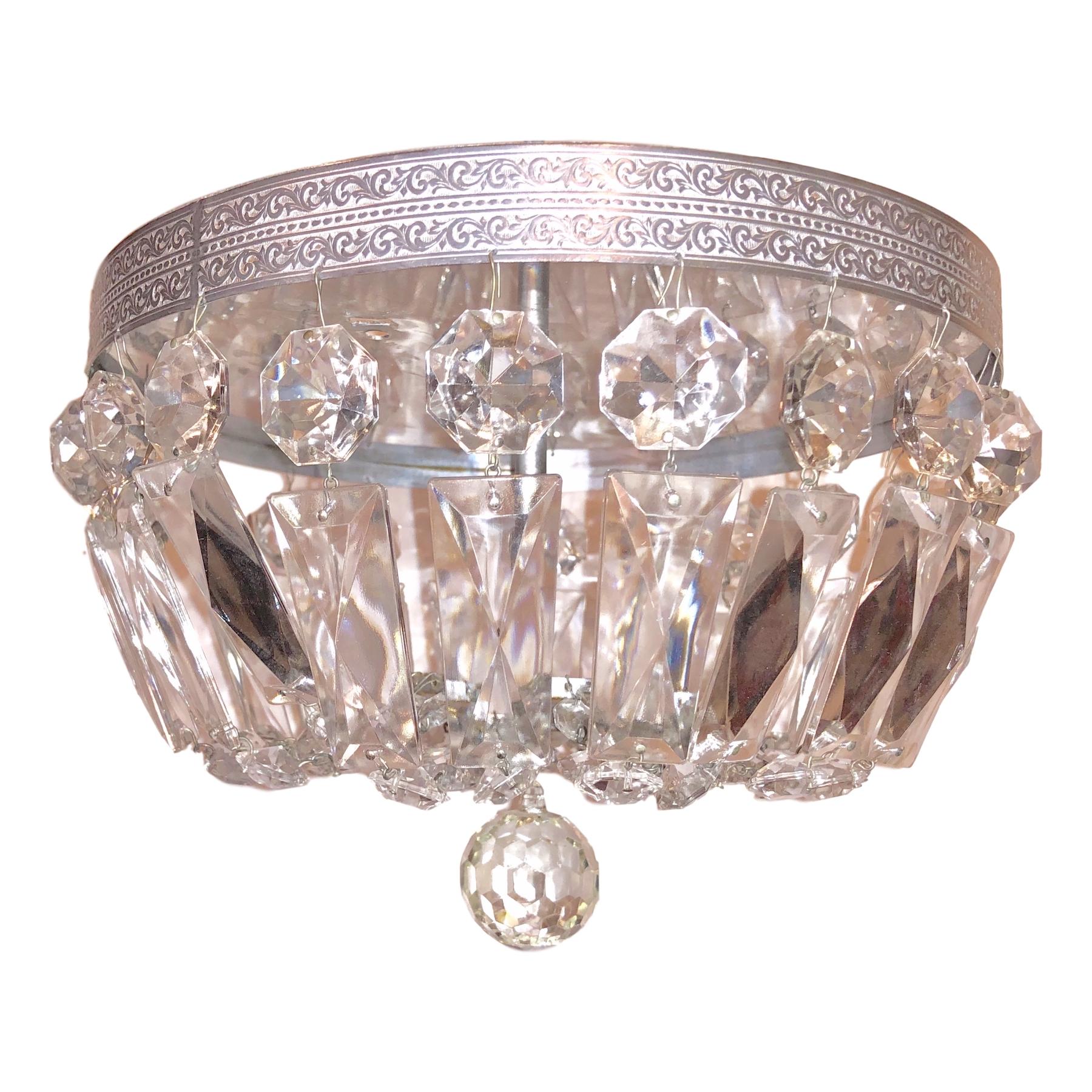 A set of three circa 1950s French crystal flush-mounted silver plated fixtures.

Measurements:
Drop 8