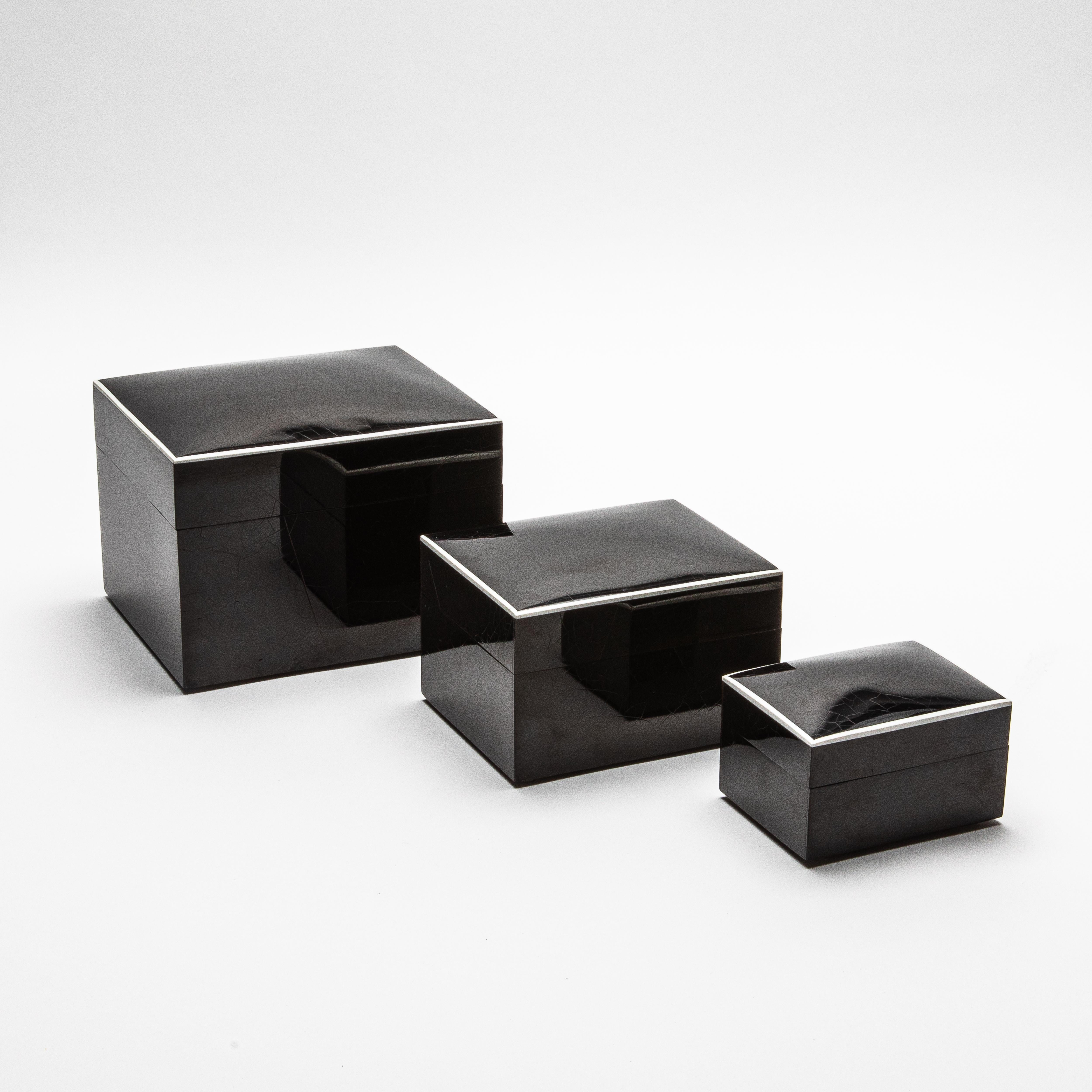 This exquisite set of three curved top boxes, handcrafted from luxurious pen shell, is a testament to R&Y Augousti’s mastery of artisanal craftsmanship. Each box boasts a sleek, lustrous surface that captures the natural beauty of the pen shell's