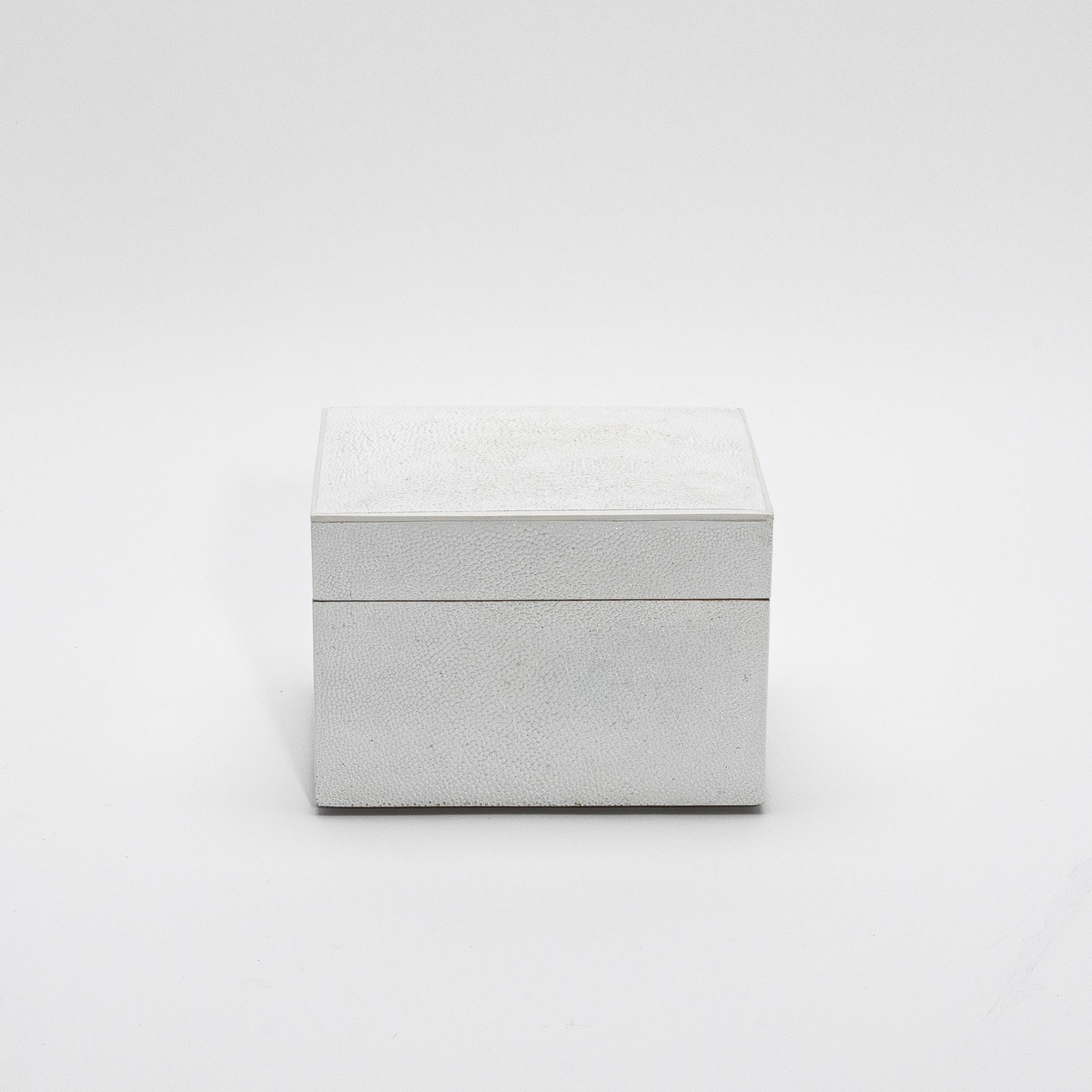Este exquisito juego de tres cajas superiores curvadas de R&Y Augousti encarna a la perfección el equilibrio entre el diseño atemporal y la artesanía de lujo. Cada caja está meticulosamente hecha a mano, envuelta en un blanco impoluto que ofrece una