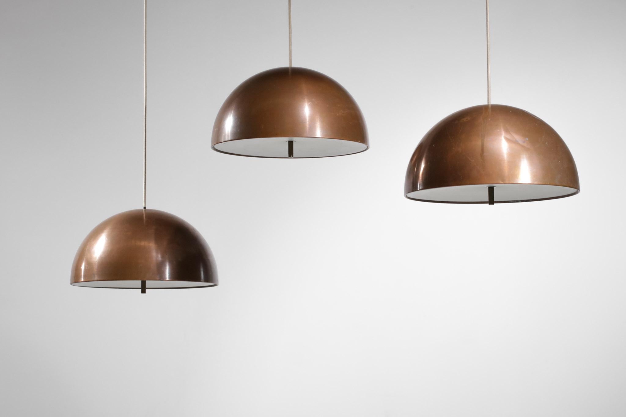Set of three Scandinavian 1960s pendant lamps by Danish designer Jo Hammerborg. Copper lampshade and white plastic diffusers requiring three bulbs per suspension. Nice vintage condition, please note traces of use and time on the shades (see