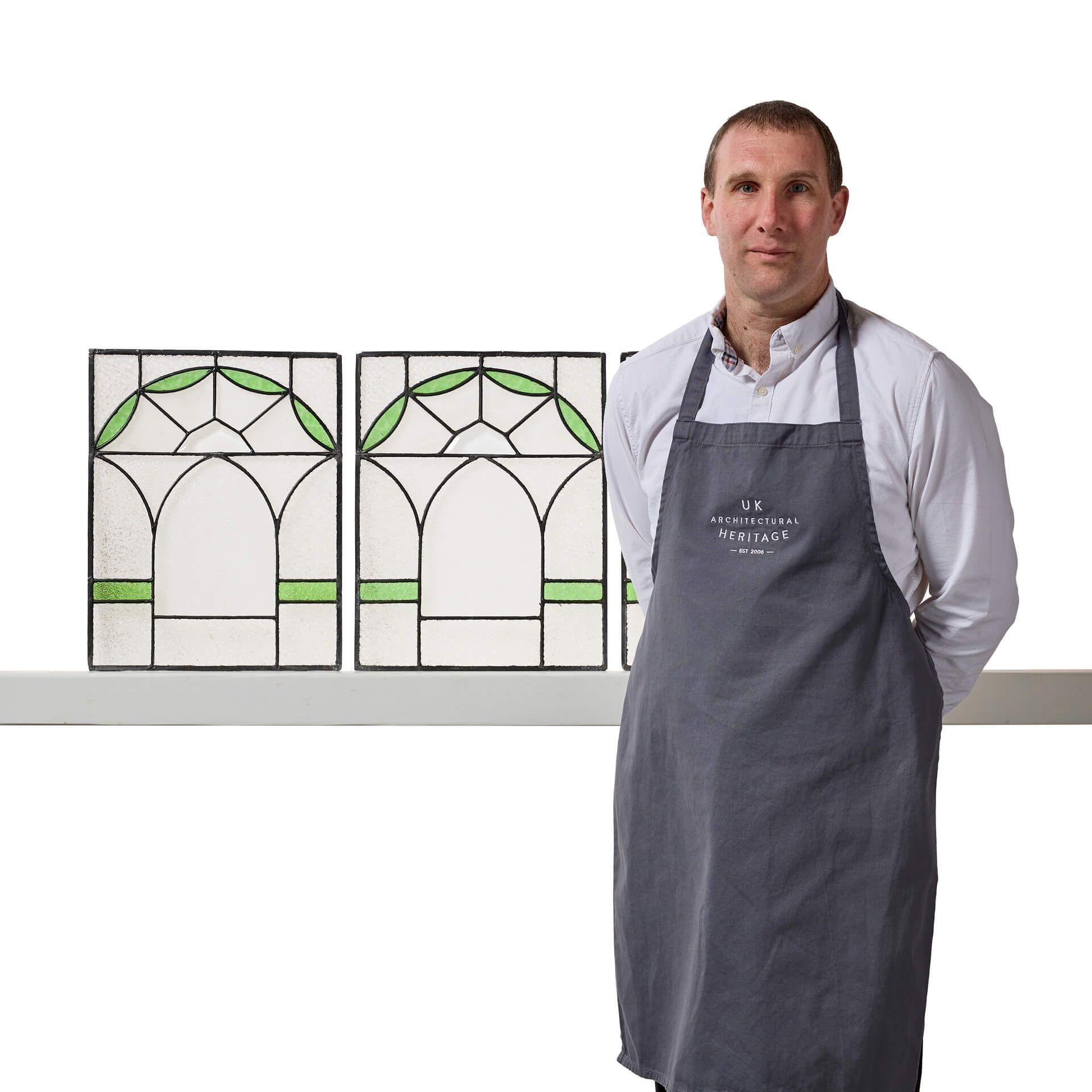 A set of three Edwardian stained glass panels dating to circa 1910.

Each window is of a matching design, the clear textured leaded glass artistically hand painted to create a pleasing geometric, art nouveau style pattern, displaying arches with