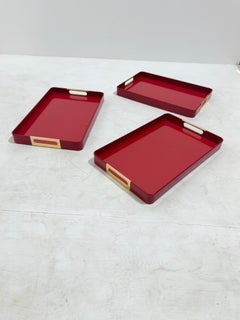 Set of 3 enameled metal and brass Trays, MB Italia, 1960s.