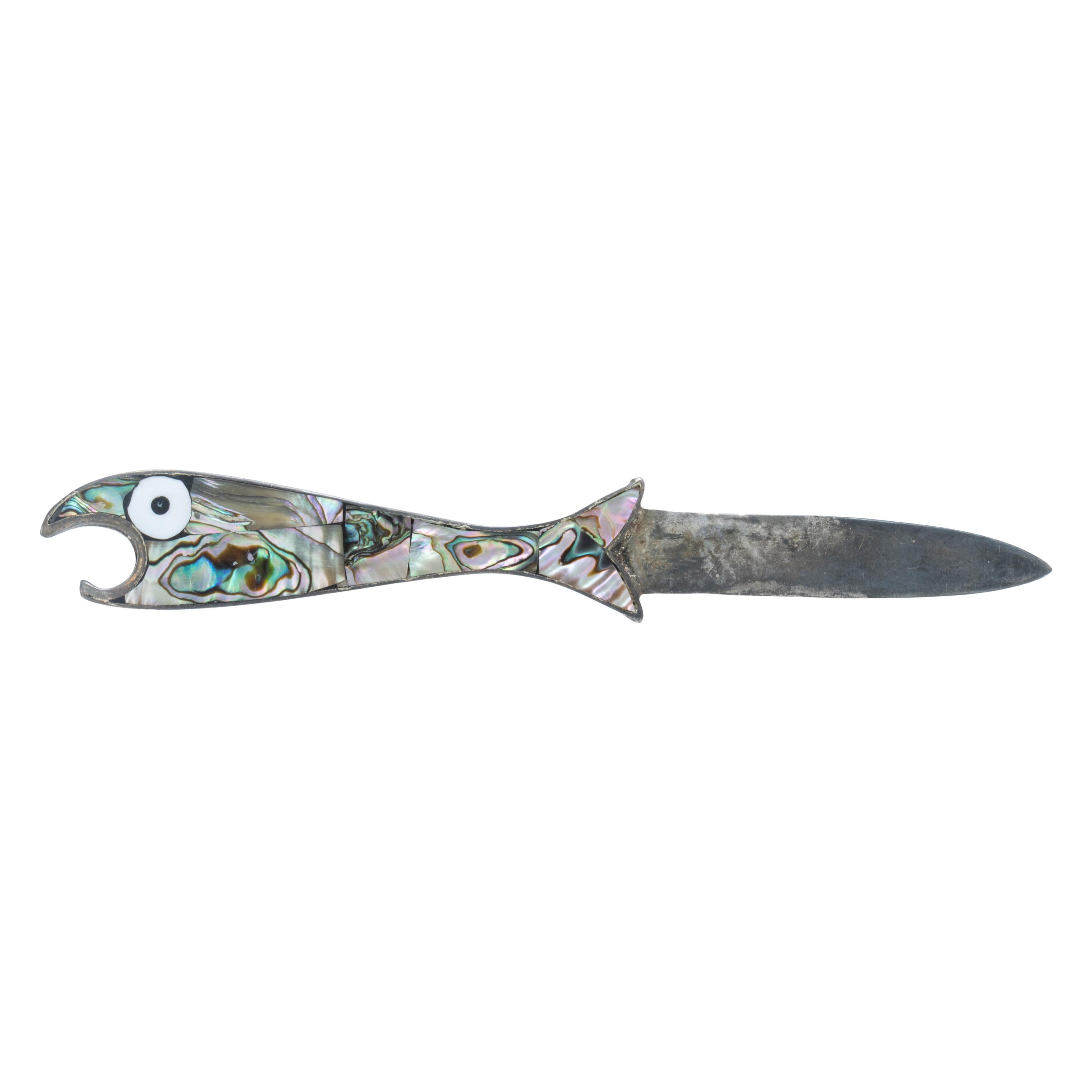 Set of three matching abalone fish botte openers with knives. Bodies are completely overlaid with abalone shell in lovely swirling colors of silver, purple, blue, green, and black. Fish are stylized with comically large white and black eyes and thin
