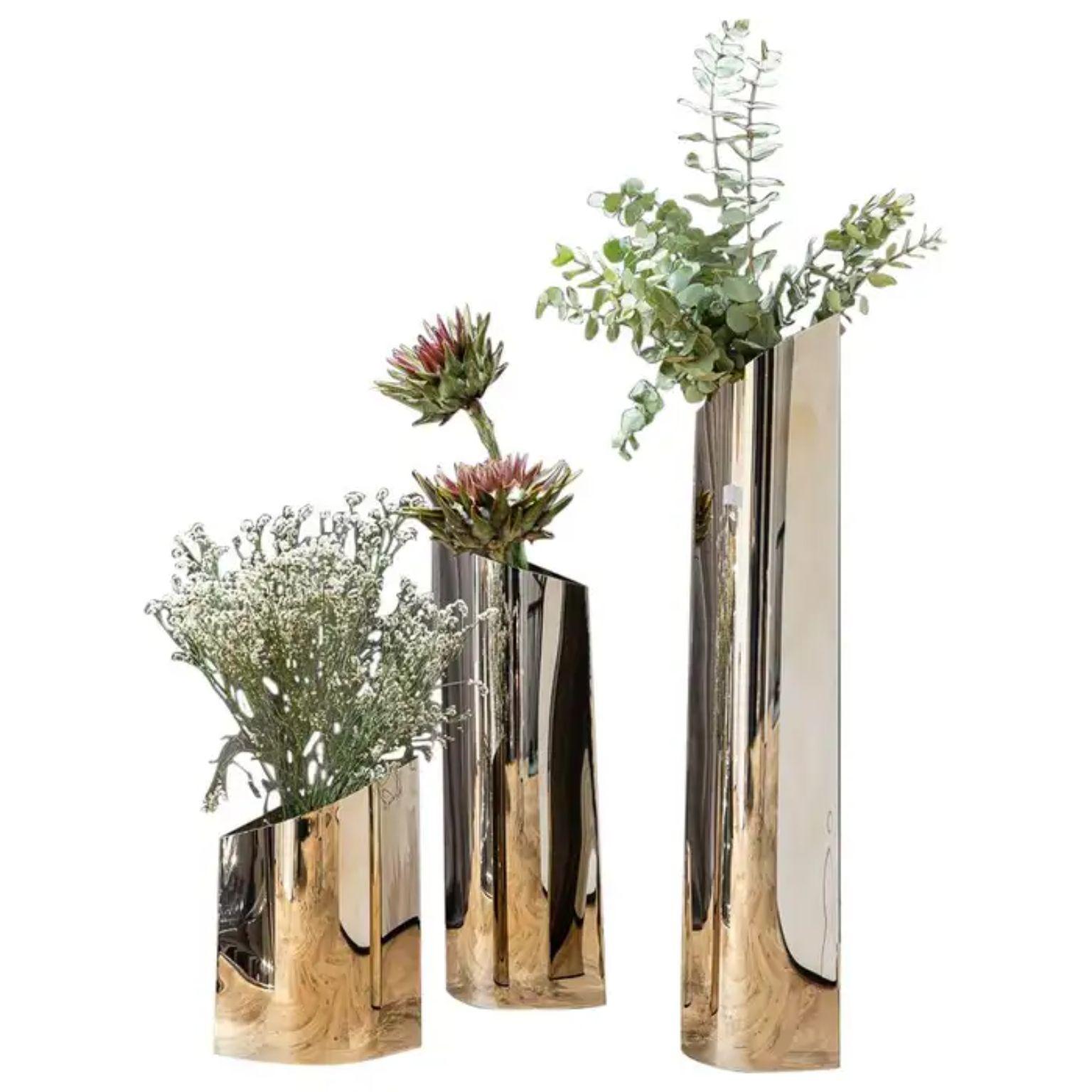 Set of 3 Flamed Gold Parova L Vases by Zieta
Dimensions: Vase L35:  D 17 x W 24 x H 35 cm.
Vase L60:  D 20 x W 22 x H 60 cm.
Vase L85: D 13 x W 19 x H 85 cm.
Materials: Flamed gold stainless steel.

Zietas main goal is to deliver uniqueness and