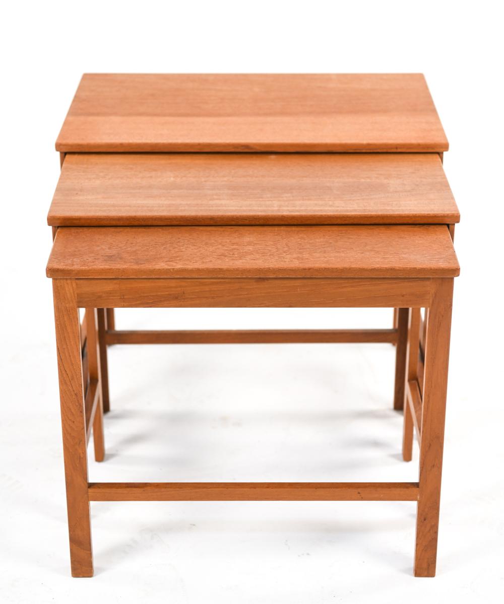 A set of three Danish mid-century elegant square nesting tables in teak by France & Son, in the manner of Kaare Klint. Featuring solid, stable construction that allow the tables to nest tightly.