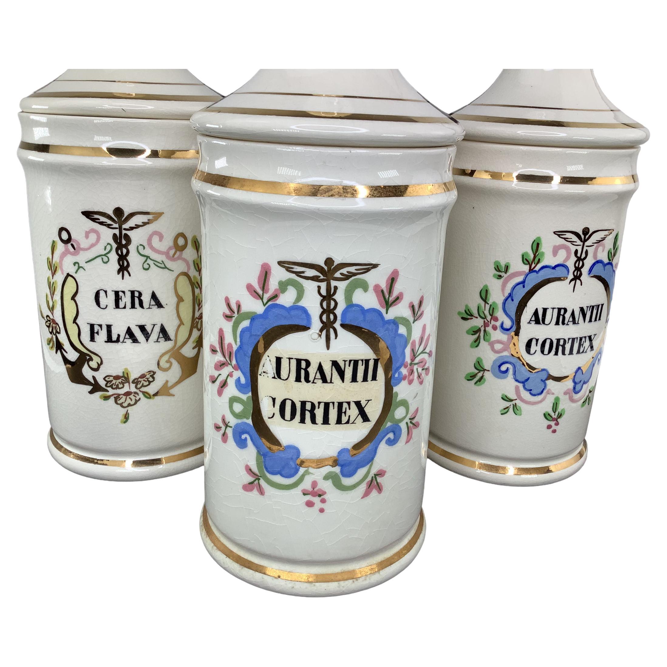 Set of 3 French Antique Porcelain Apothecary Jars. Each with the corresponding names of the drugs that was contained in the jars. Hand decorated with floral motifs and trimmed in 22k gold. All three are god vintage condition with no visible chips or