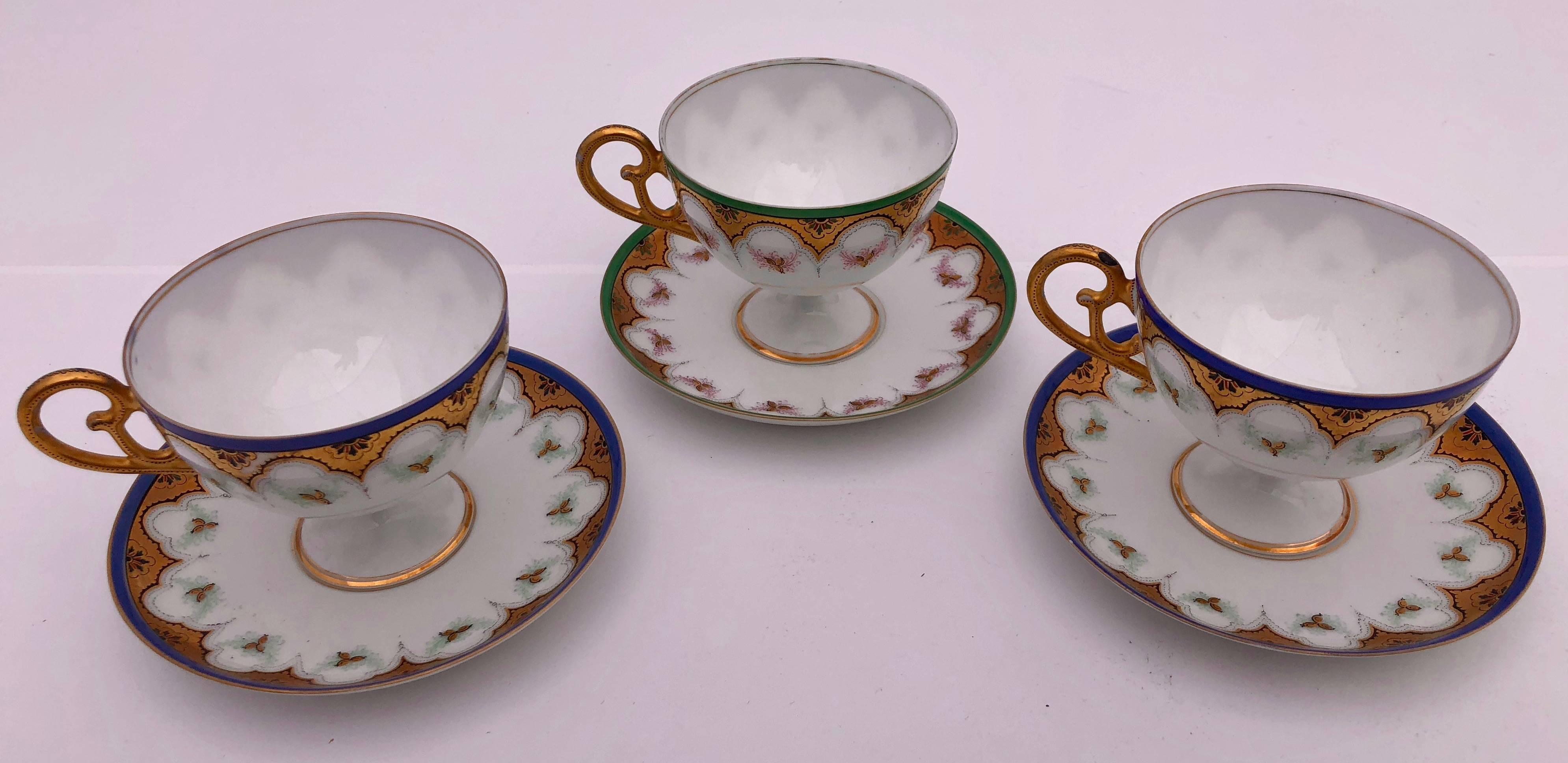 These are three lovely French bone china tea cups with a pedestal bottom and their saucers. All have a white background with gold accents and share the same design while two are blue and gold and one is green and gold. They have no markings, but