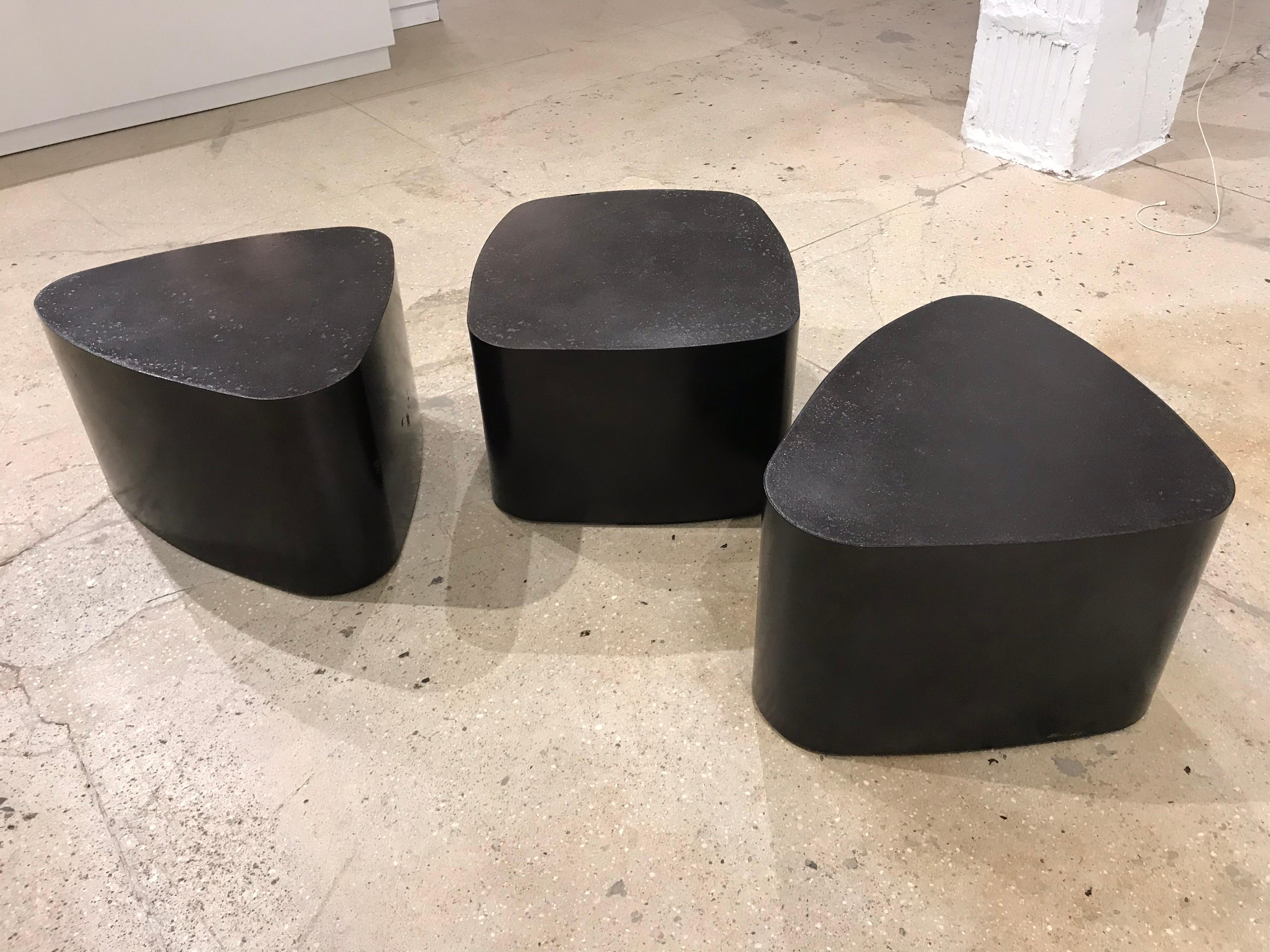 A set of 3 coffee or side tables custom made by French designer ,Stephane Ducatteu . The metal bases have a very dark bronze finish and the black tops are a custom stone composite. Signed.

One table is 12” H x 20 1/4” x 18.5” 2 table is 13” H x 22”
