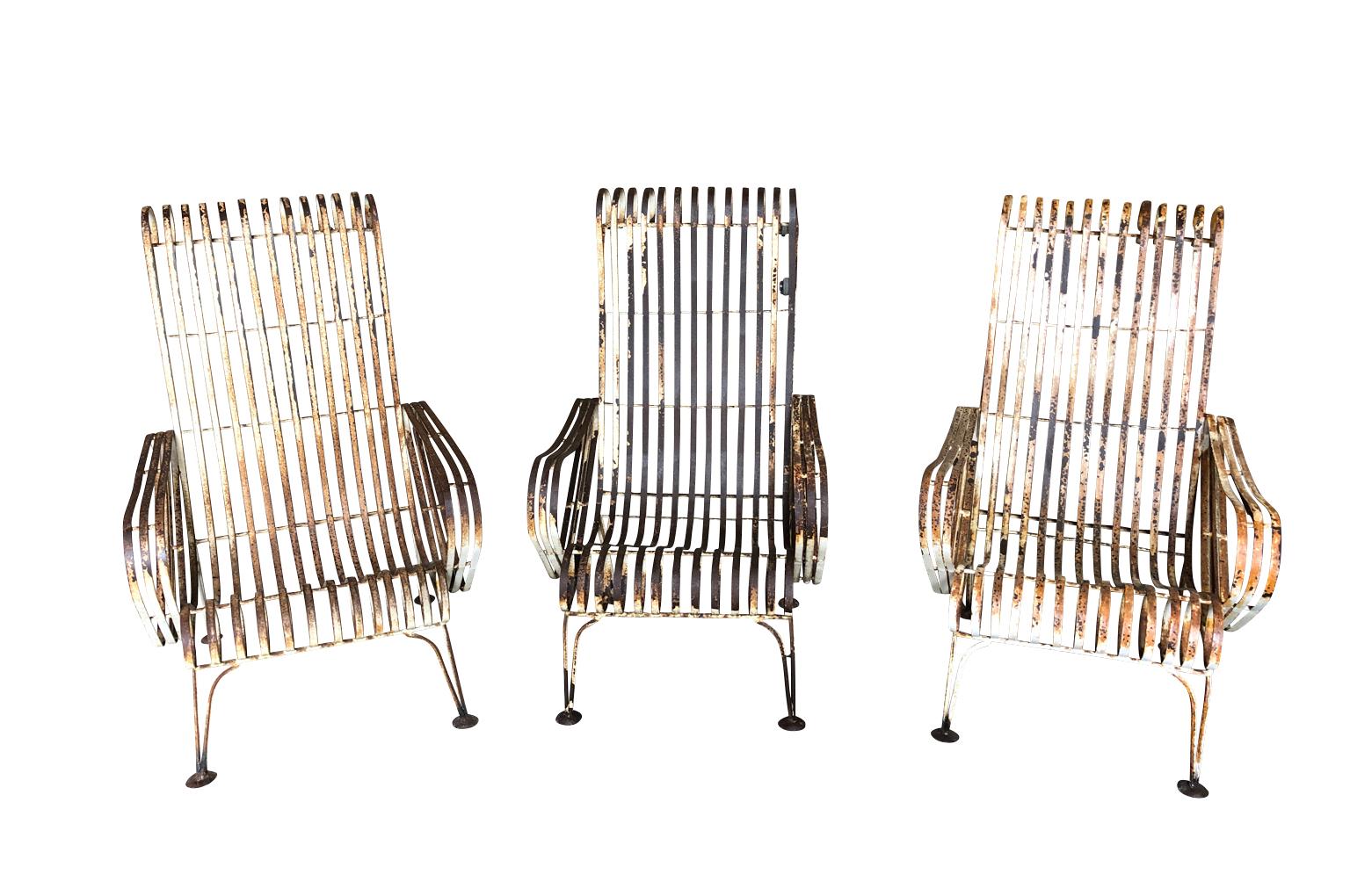 A terrific set of 3 mid-20th century garden armchairs from the Provence region of France. Sturdily constructed from painted iron with a wonderful patina. Very comfortable. A wonderful addition to any garden, solarium or porch.