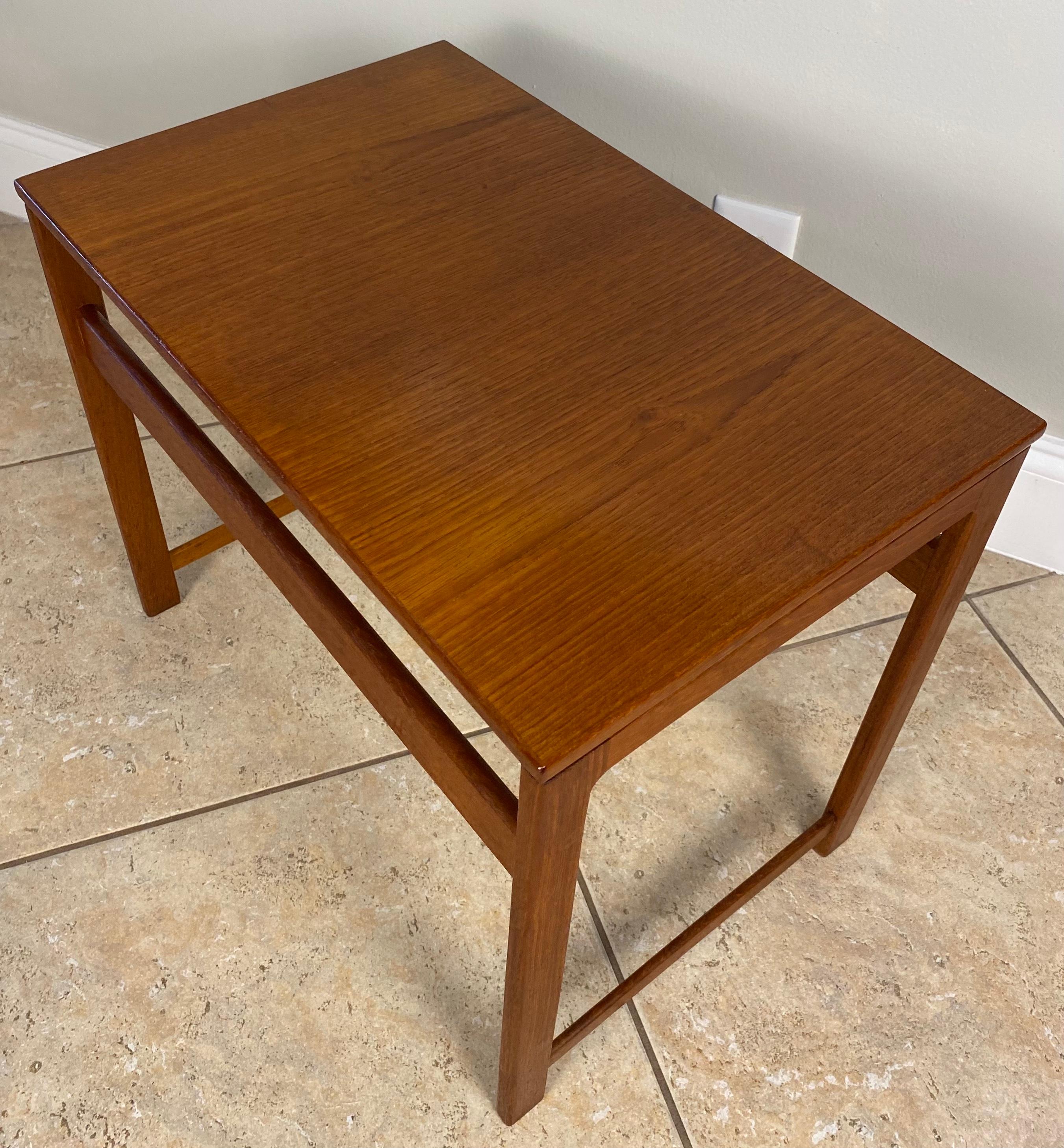 A very nice quality set of 3 French mid 20th century wooden nesting tables. Constructed in durable teak. Designed in a Scandinavian style, manner of Hans J. Wegner.  

These Hans Wegner style wooden nesting tables are of very good quality and would