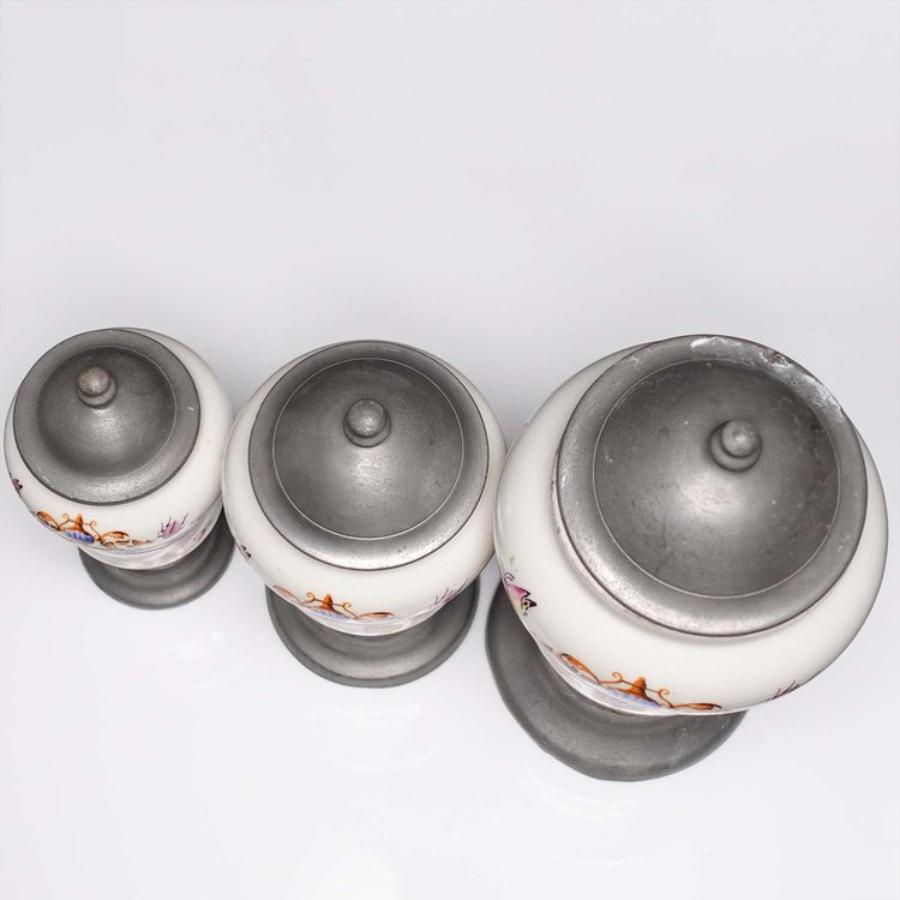 Here is a lovely set of 3 French Pewter and Porcelain Apothecary Jars. These are larger jars ranging from 7-10” in height. Each jar features a pewter base and lid housing a quality porcelain jar. Containers feature Cocaina, Opium and Arsenic on the