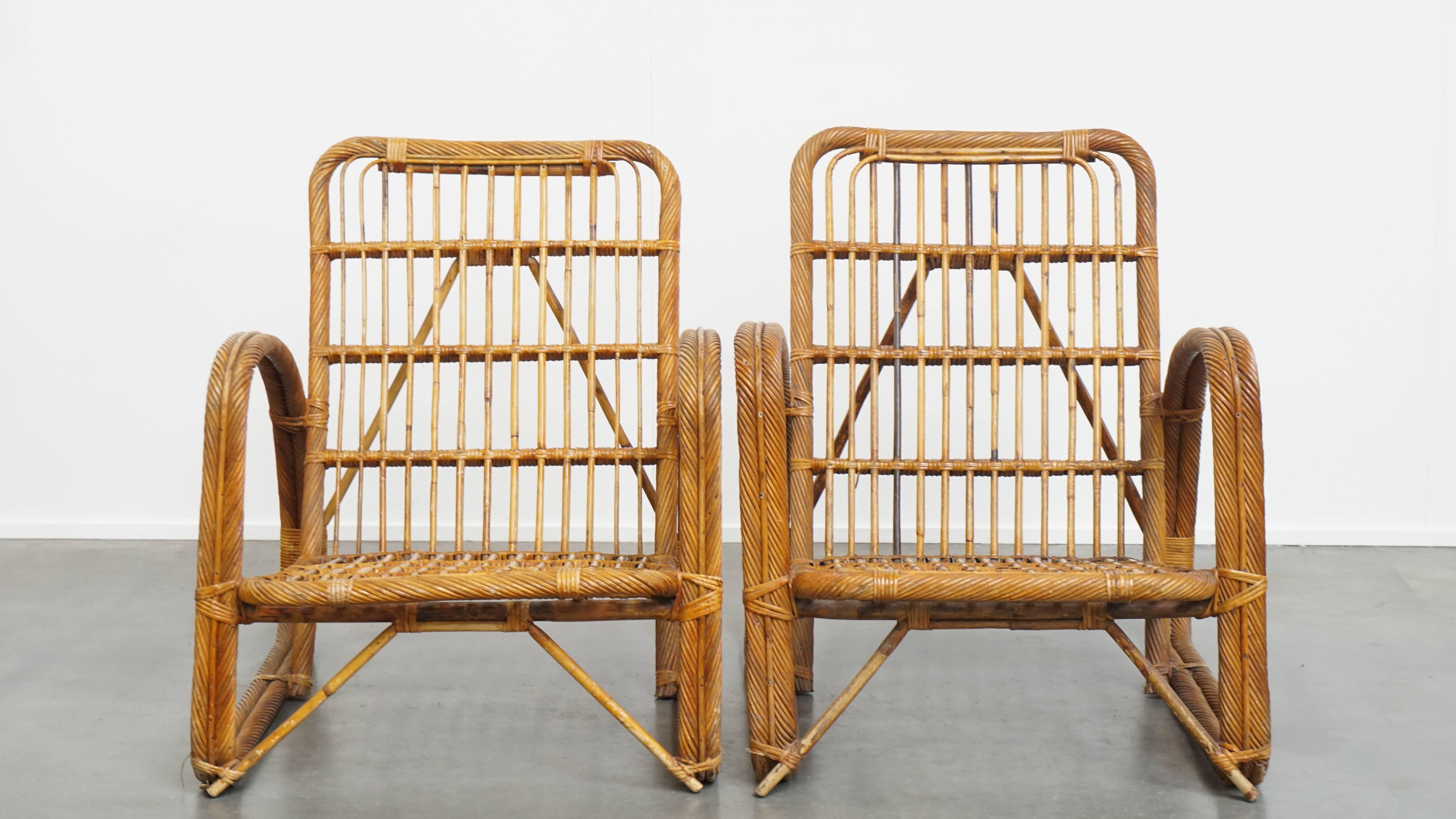 Offered is this set of 3 luxurious French rattan vintage design armchairs from the 1950s. 

This stunning set of vintage rattan chairs is a true eye-catcher, in our opinion. They are not only perfectly suited for outdoor use or under a covered