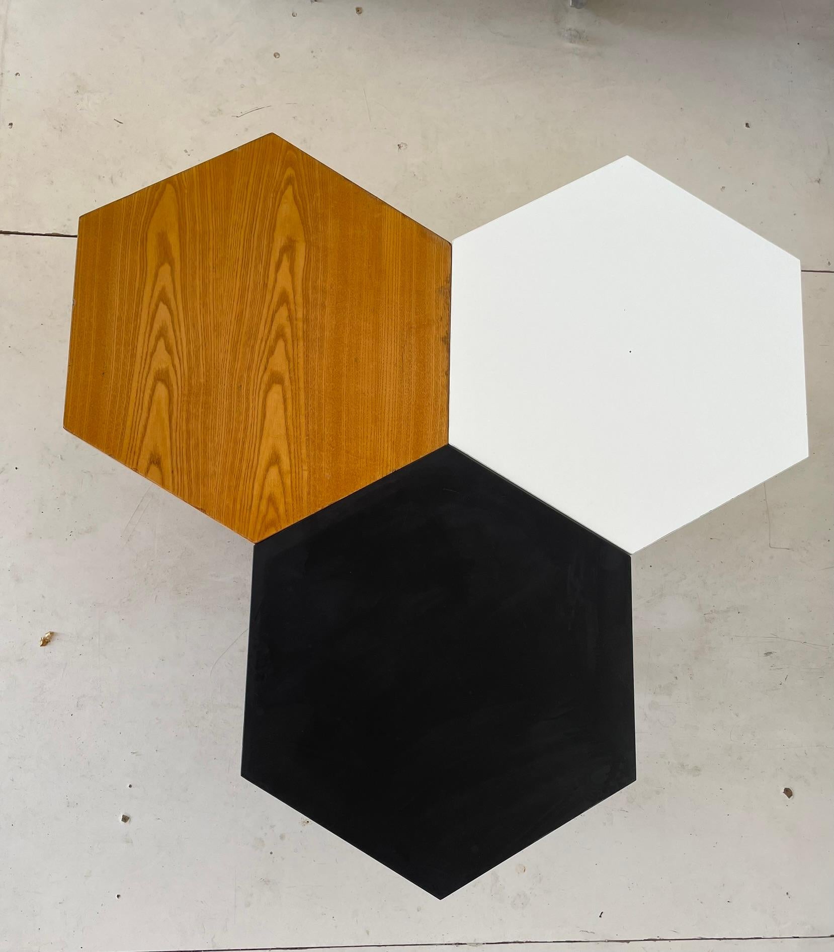 These coffee tables were designed by Gio Ponti and produced by ISA Bergamo in Italy in the 1950s.
Each table is marked with a metal manufacturer’s tag reading “ISA.”

The set consists of three tables, each featuring a hexagonal top and standing on