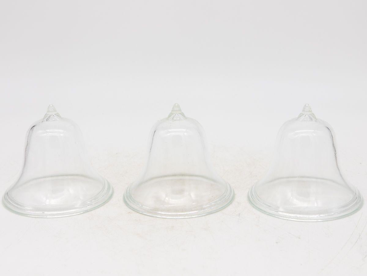 A set of three mini glass cloches. Ideal table top or bookshelf size. French midcentury. Wear consistent with age and use. Multiple sets available.