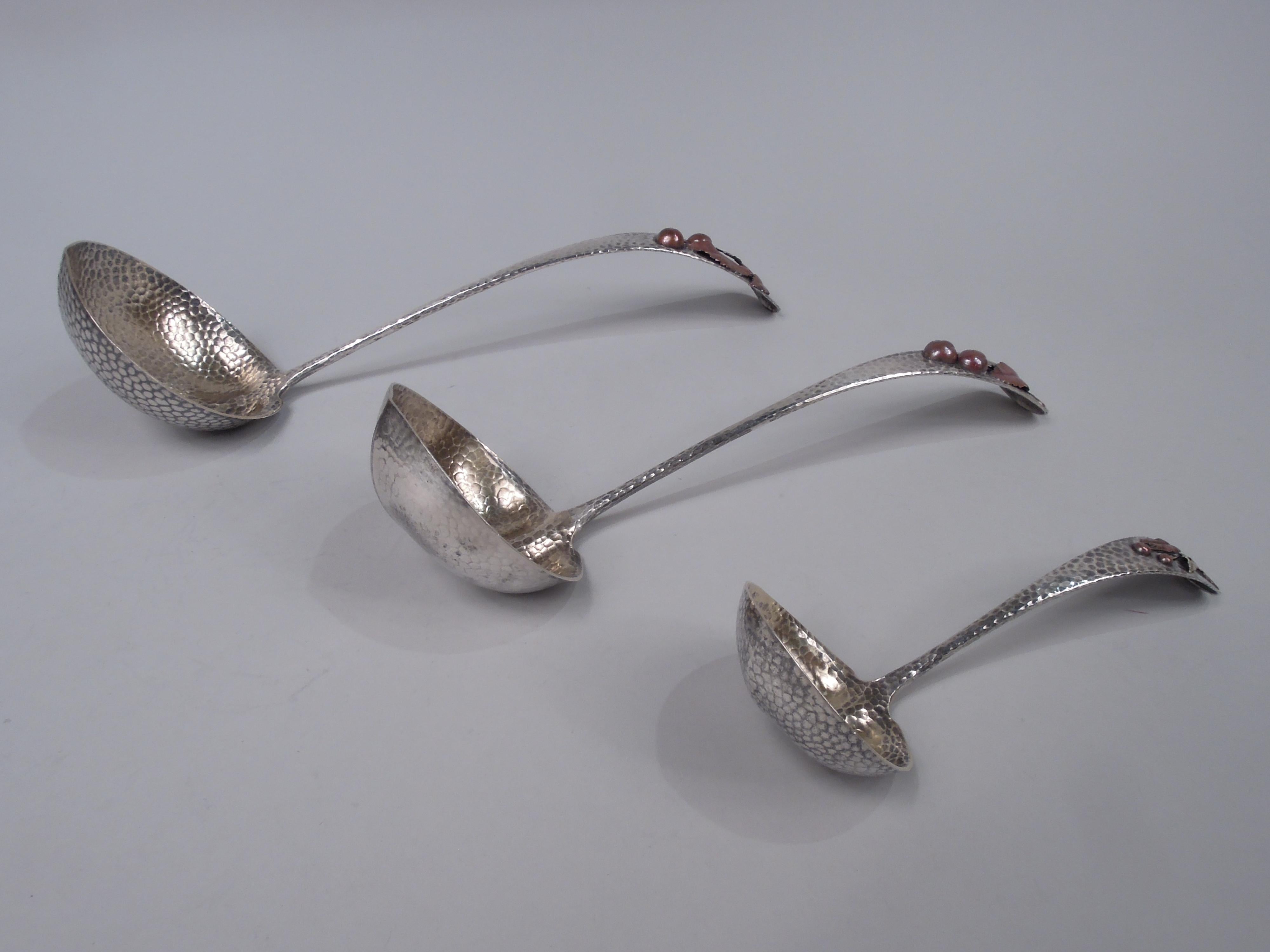 Three Japonesque sterling silver ladles. Made by Gorham in Providence, ca 1885. Each: Curved and tapering handle; round and lobed bowl with small lip spout; bowl interior gilt washed. Terminal curved with applied mixed metal cherry branch. Allover