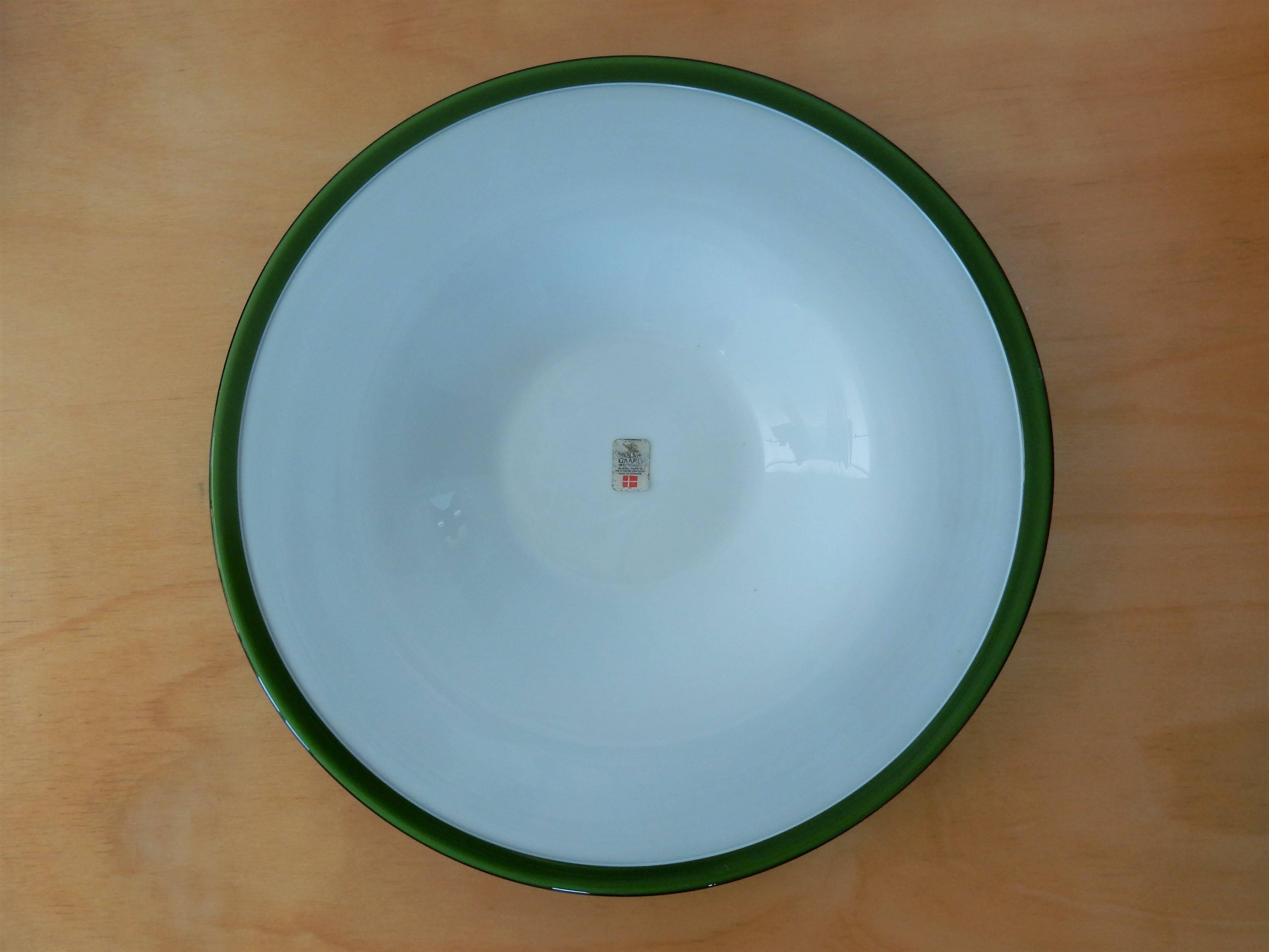 Very nice set with a small medium and a larger medium green glass bowl and a bowl plate from Kastrup-Holmegaard, designed by Michael Bang. In excellent condition with no defects. The bowls are unmarked, but we do have one original Holmegaard sticker