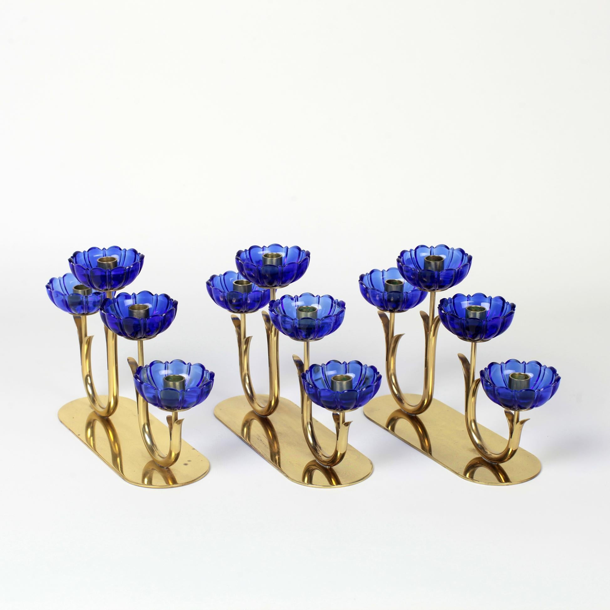 Beautiful set of 3 Gunnar Ander candleholder for Ystad Metall, Sweden
Delicate blue glass flowers and patinated gold-plated brass stems.