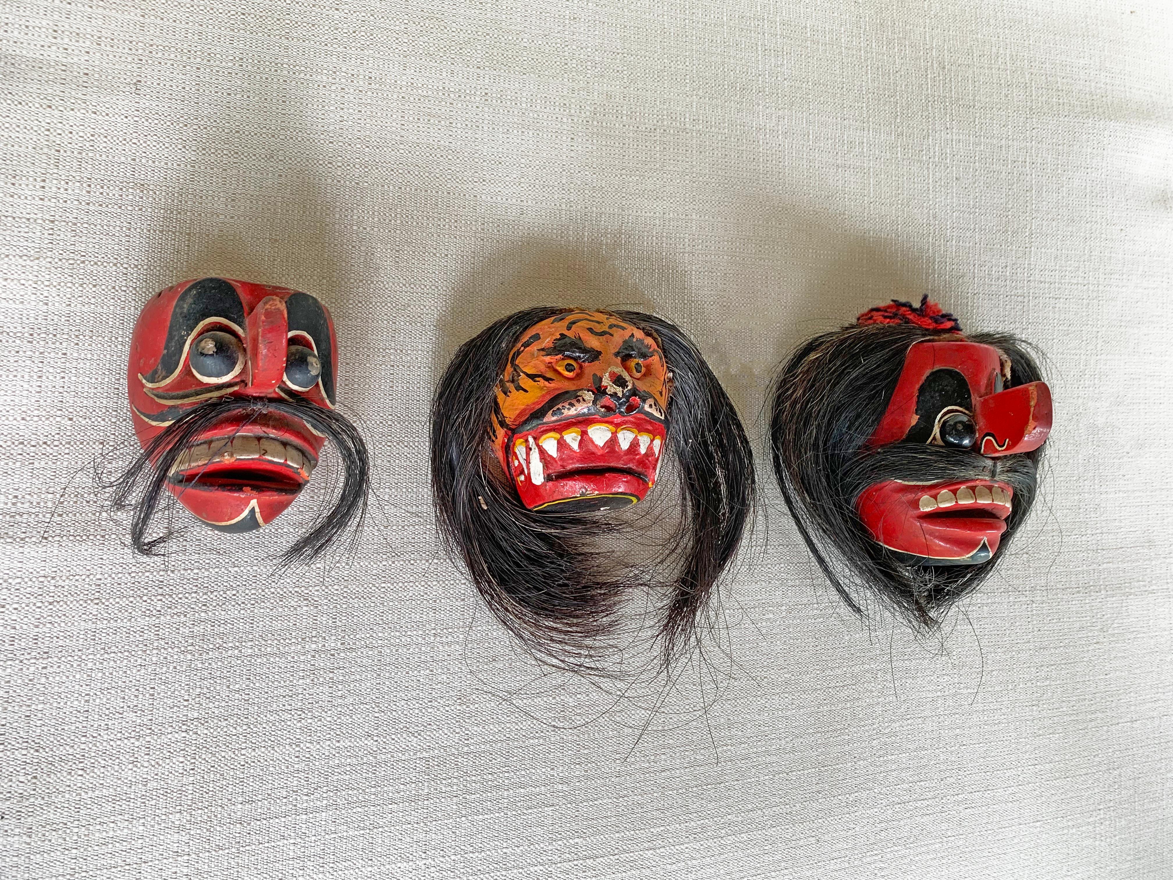 This set of 3 mid-20th century mask were sed on the island of Madura for ceremonial purposes. The island of Madura is situated off the north-eastern coast of Java. This mask features a mix of red, white & black polychrome. They also feature