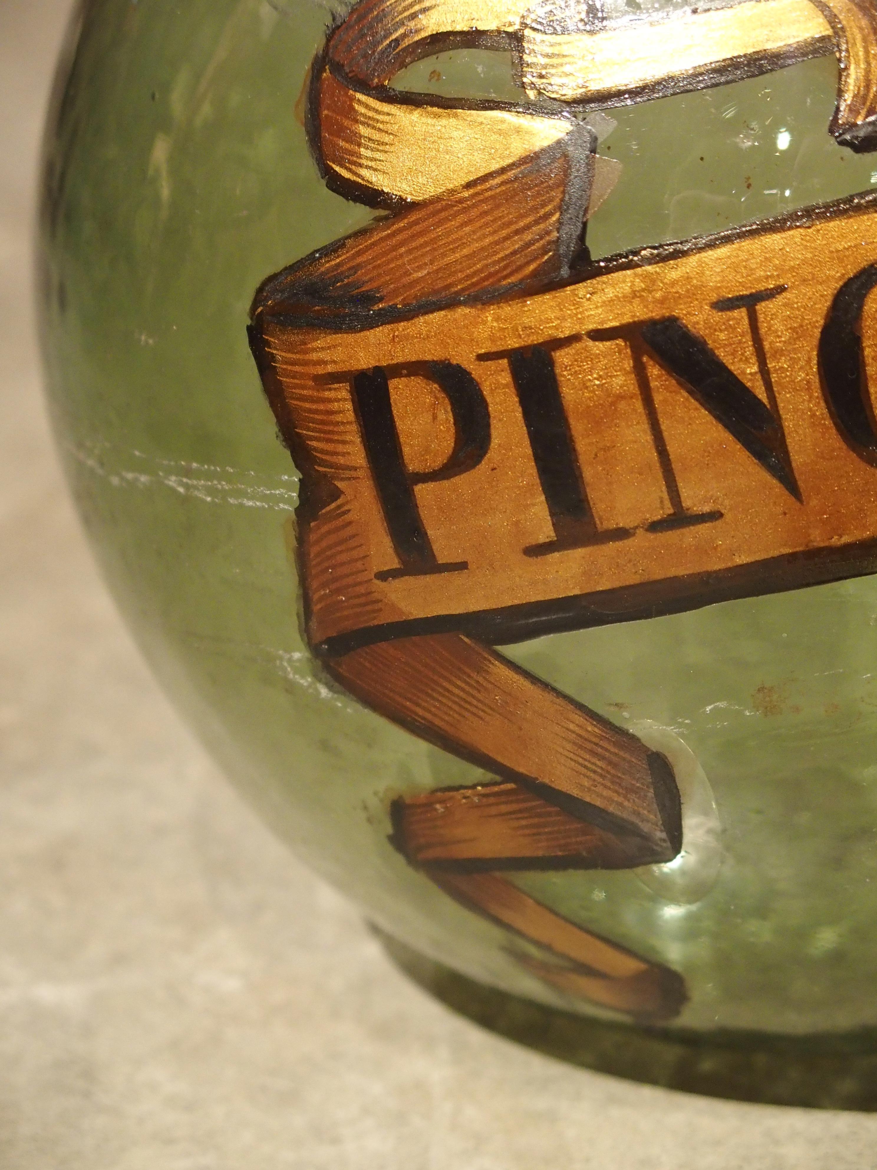 From the latter half of 19th century France (circa 1880), this set of three demijohn bottles have hand painted banners that identify types of wine: Merlot, Pinot Noir and Cabernet.

You might notice air bubbles trapped in our green translucent