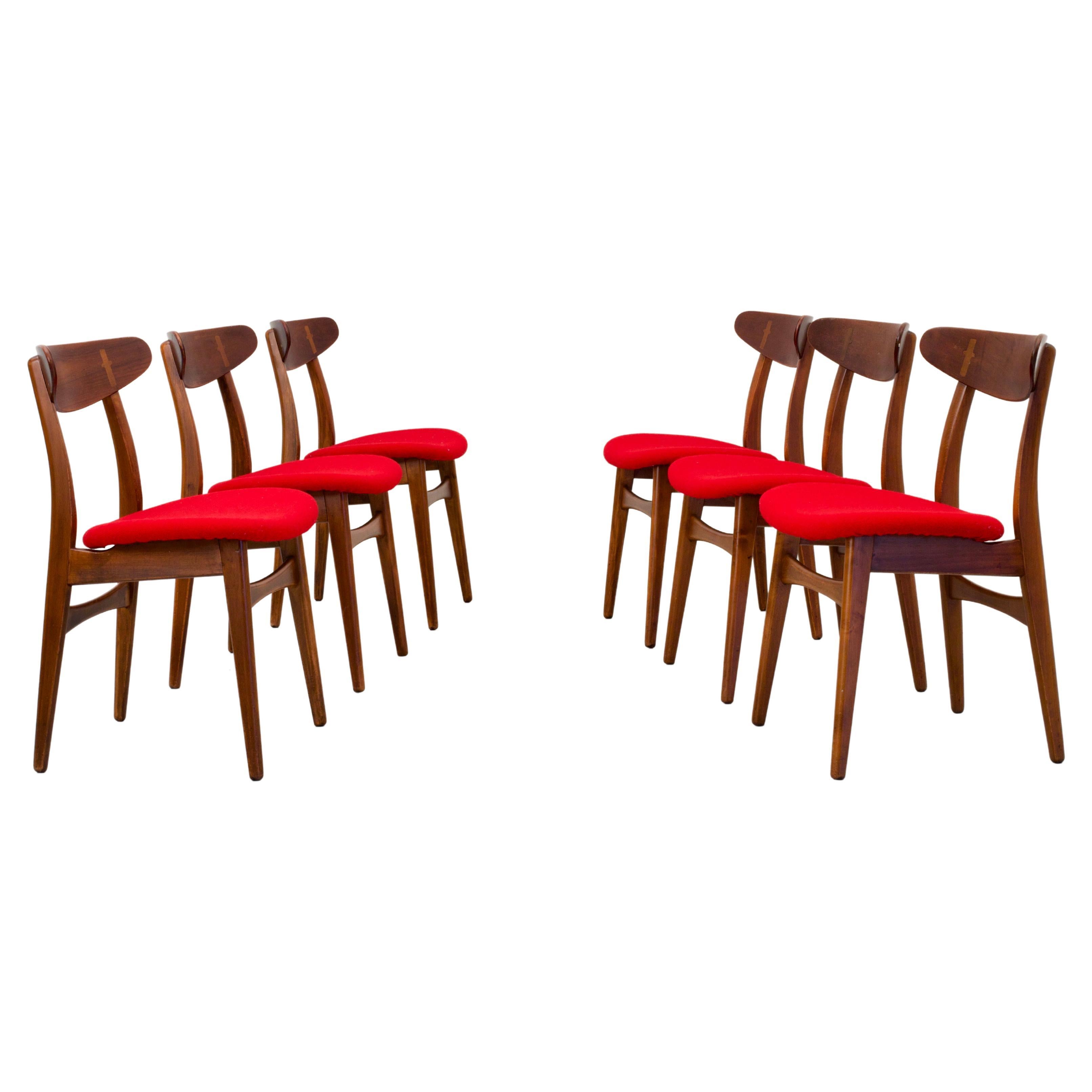 Set of 3 (not two!) CH30 dining chairs by Hans Wegner in Oak and Teak and red upholstery.

This 1954 design is one of the outcomes of Wegner's ongoing search for the ideal chair. The curved organic shapes and the refined details make this chair a