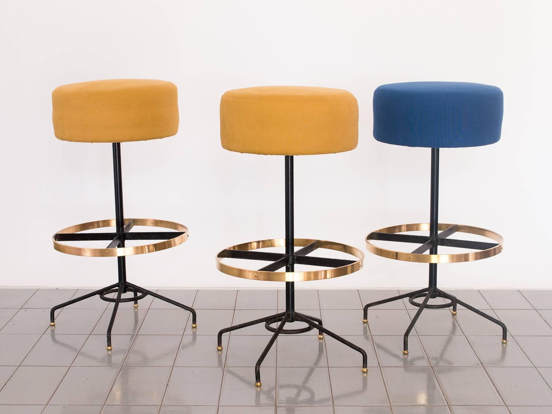 1950's set of three bar stools in iron and brass designed by Borsoi. Beautiful high cushions makes them extremely comfortable and the brass ring seals the deal on the looks department. Unique.

In 2017, we discovered a collection of Mid-Century