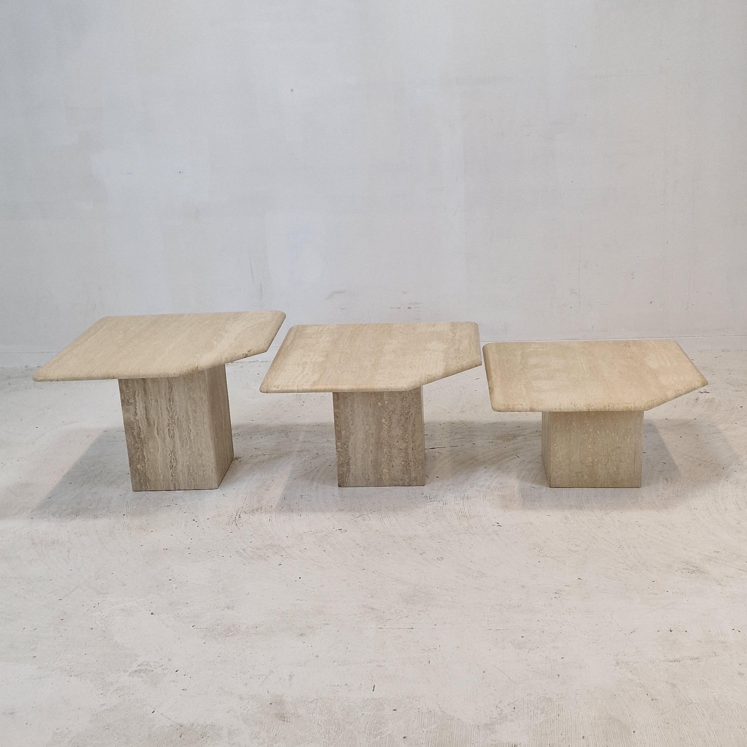 Stunning set of 3 Italian coffee or side tables, handcrafted out of travertine. 
They can be used inside or outside the house.

The tables all have a different height so they fit under each other. 

The plate and the base are made of beautiful