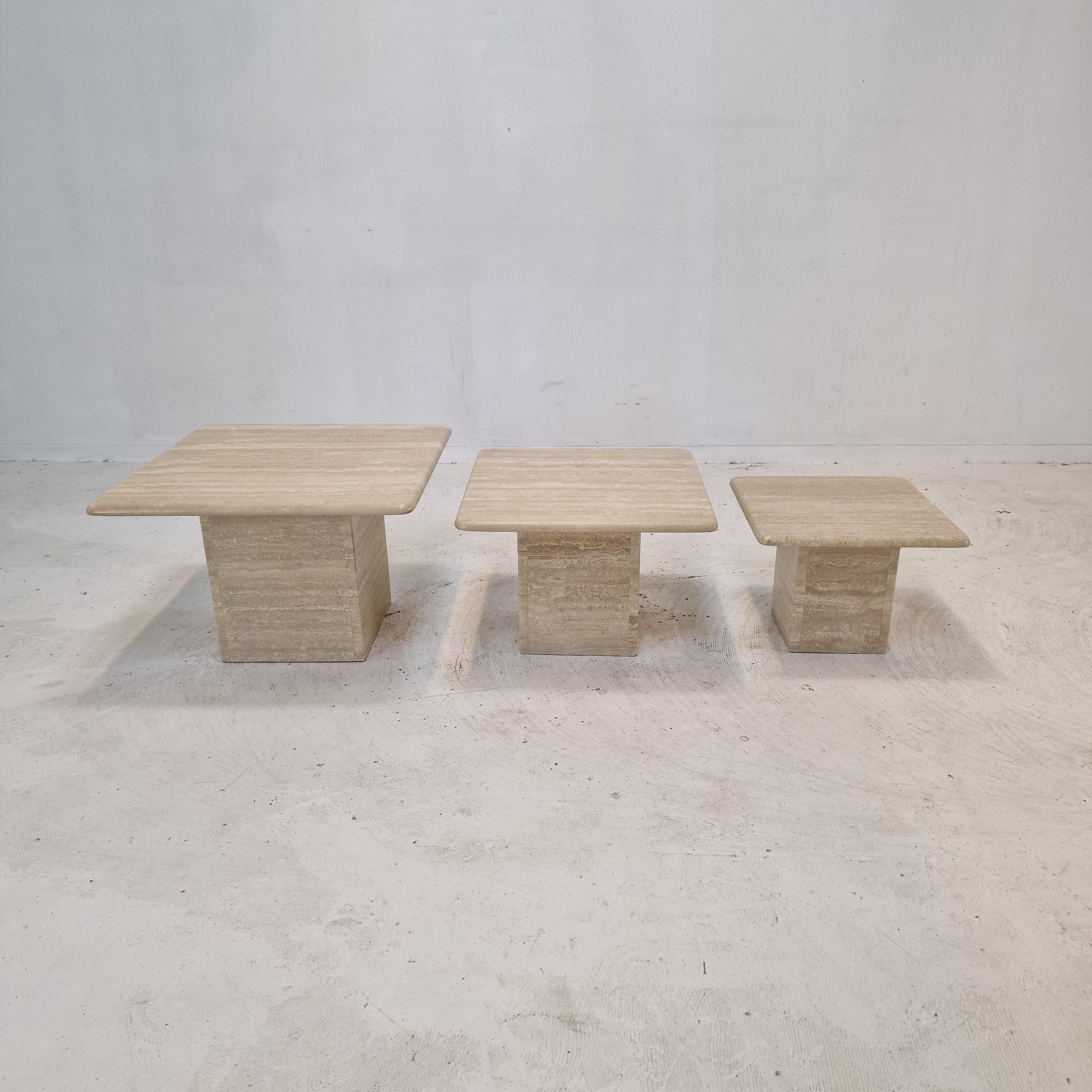 Stunning set of 3 Italian coffee or side tables, handcrafted out of travertine. 
They can be used inside or outside the house.

The tables all have a different height so they fit under each other. 

The plate and the base are made of beautiful