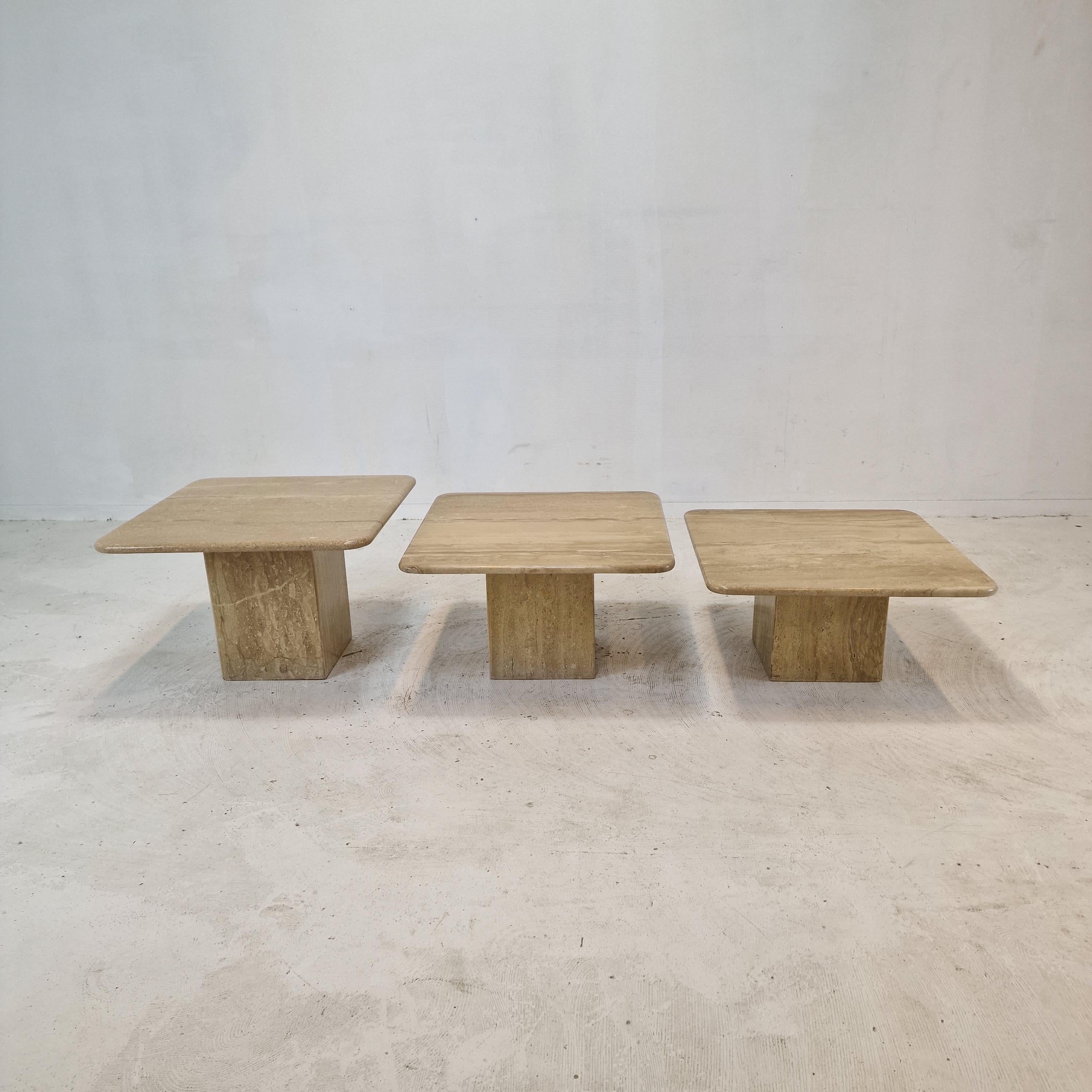 Stunning set of 3 Italian coffee or side tables, handcrafted out of travertine. 
They can be used inside or outside the house.

The tables all have a different height so they fit under each other. 

The plate and the base are made of beautiful