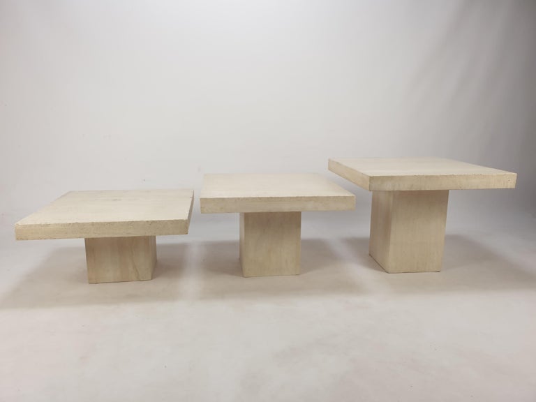 Very nice set of 3 Italian coffee tables or side tables, handcrafted out of travertine. 
They can be used inside or outside the house.

The tables have all a different height so they fit under each other. 

The plate and the base are made of