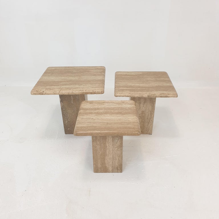 Very nice set of 3 Italian coffee tables or side tables, handcrafted out of travertine. 
They can be used inside or outside the house.

The tables have all a different height so they fit under each other. 

The plate and the base are made of