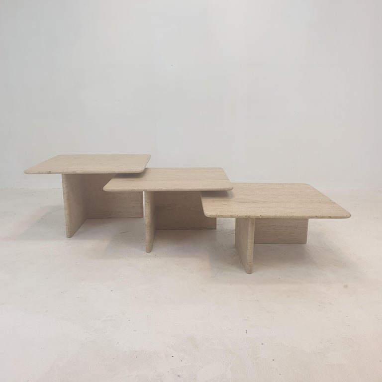 Very nice set of 3 Italian nesting- or coffee tables, handcrafted out of travertine. 
They can be used inside or outside the house.

The tables all have a different height so they fit under each other. 

The plate and the base are made of