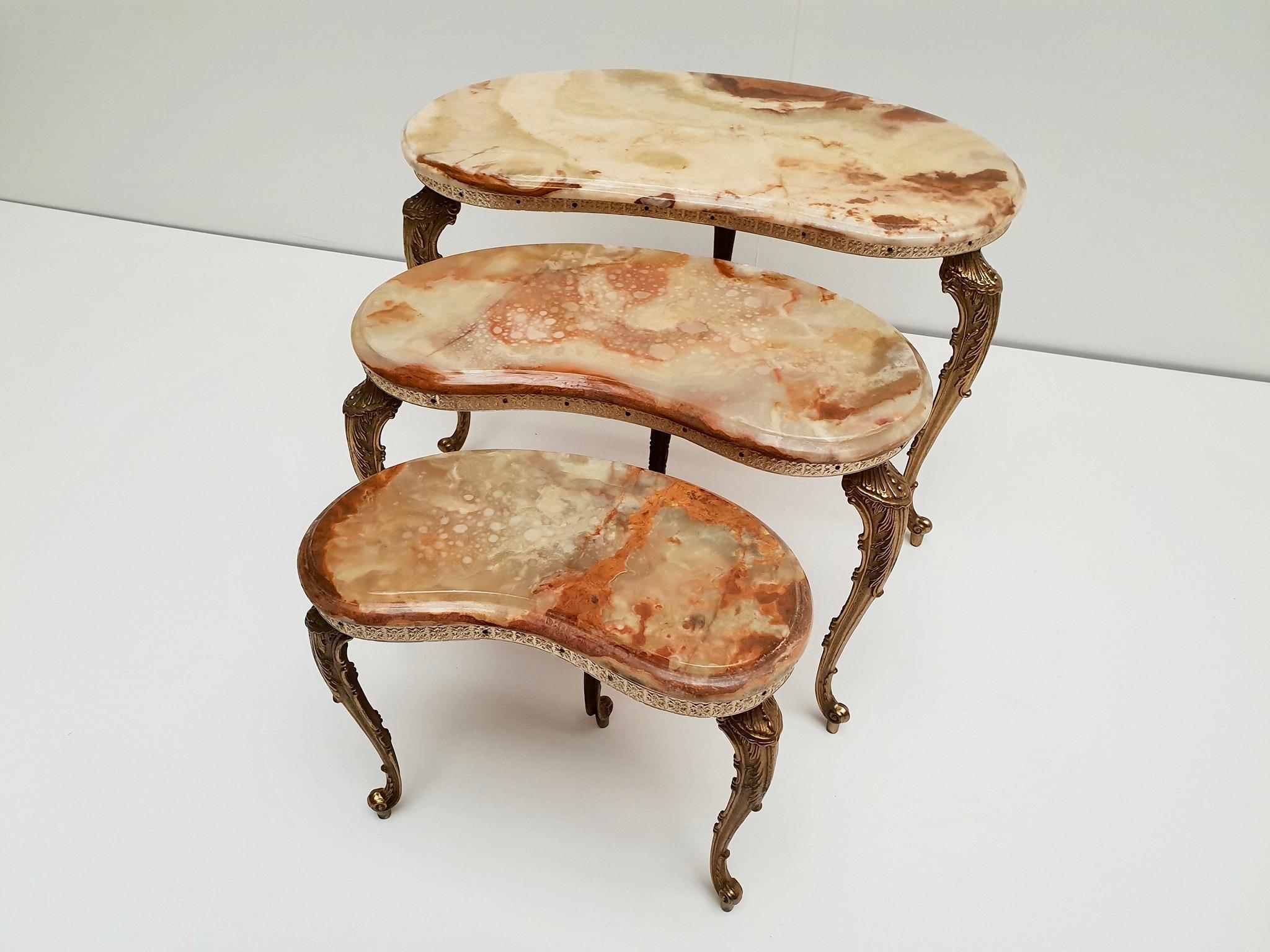 A set of 3 vintage Italian marble nesting tables with polished brass frame.
Measures: Height 43 - 38 - 34 cm. 
Width 62 - 47 - 36 cm. 
Depth 35 - 30 - 20 cm.
