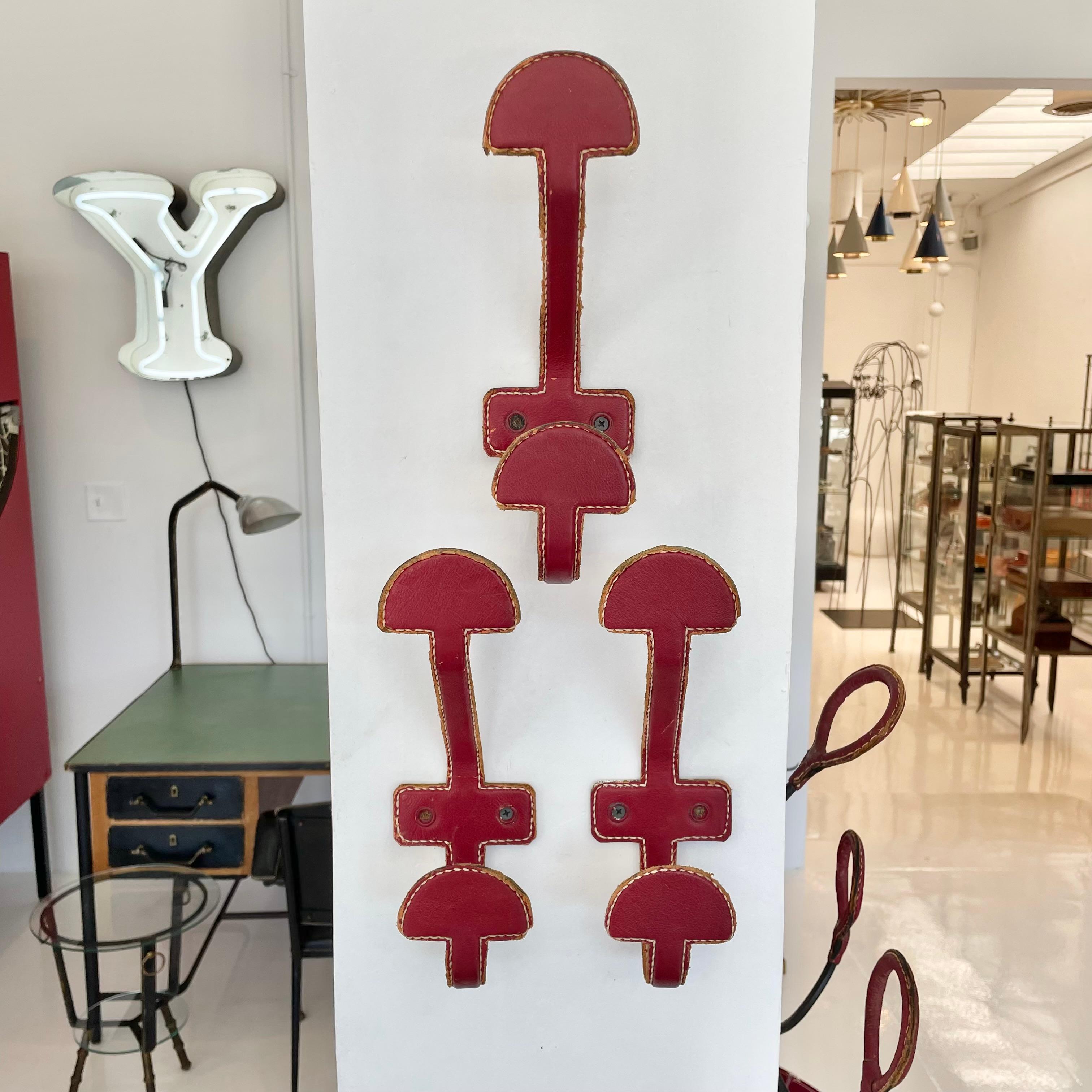 Art Deco Set of 3 Jacques Adnet Red Leather Coat Hooks, 1950s France For Sale