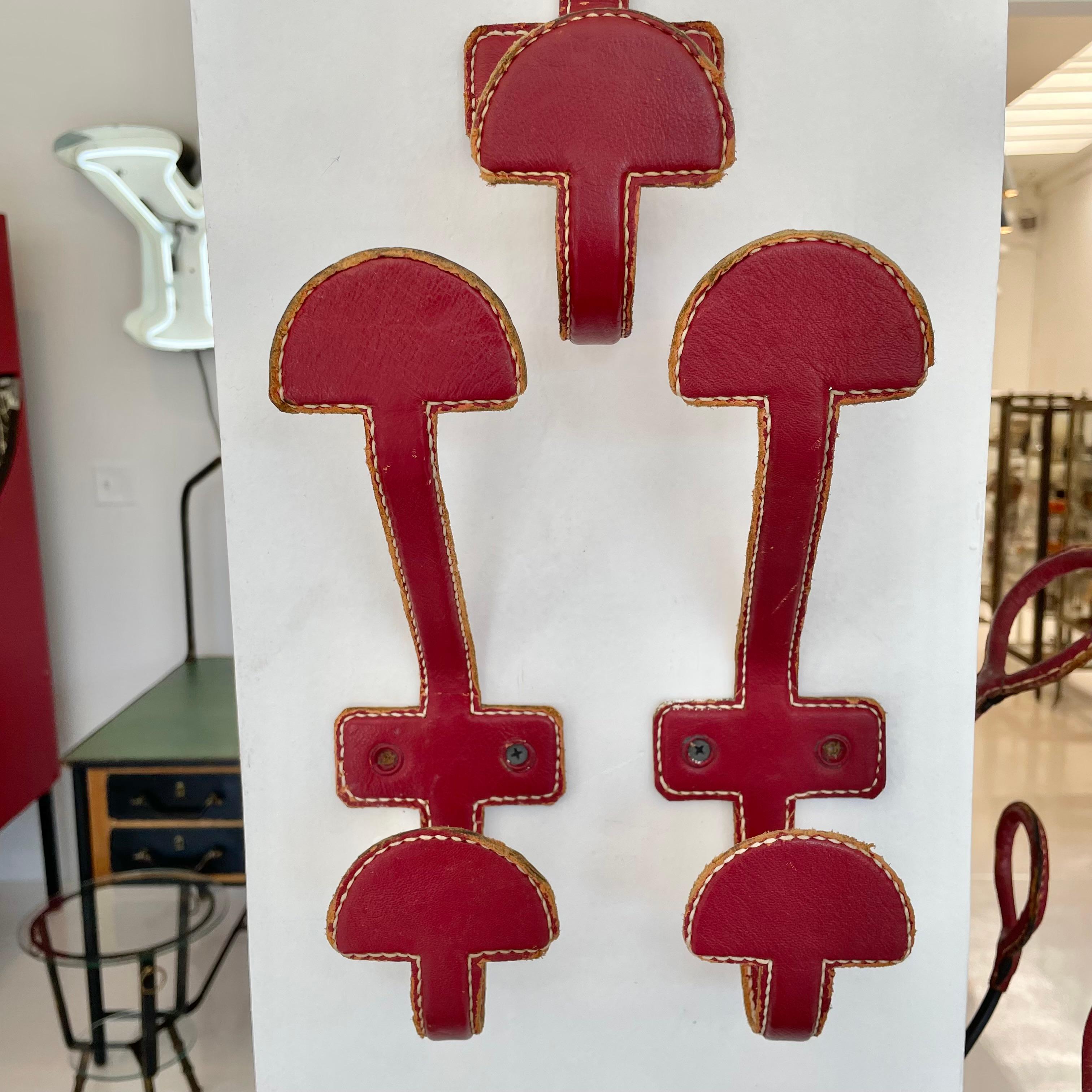 Mid-20th Century Set of 3 Jacques Adnet Red Leather Coat Hooks, 1950s France For Sale