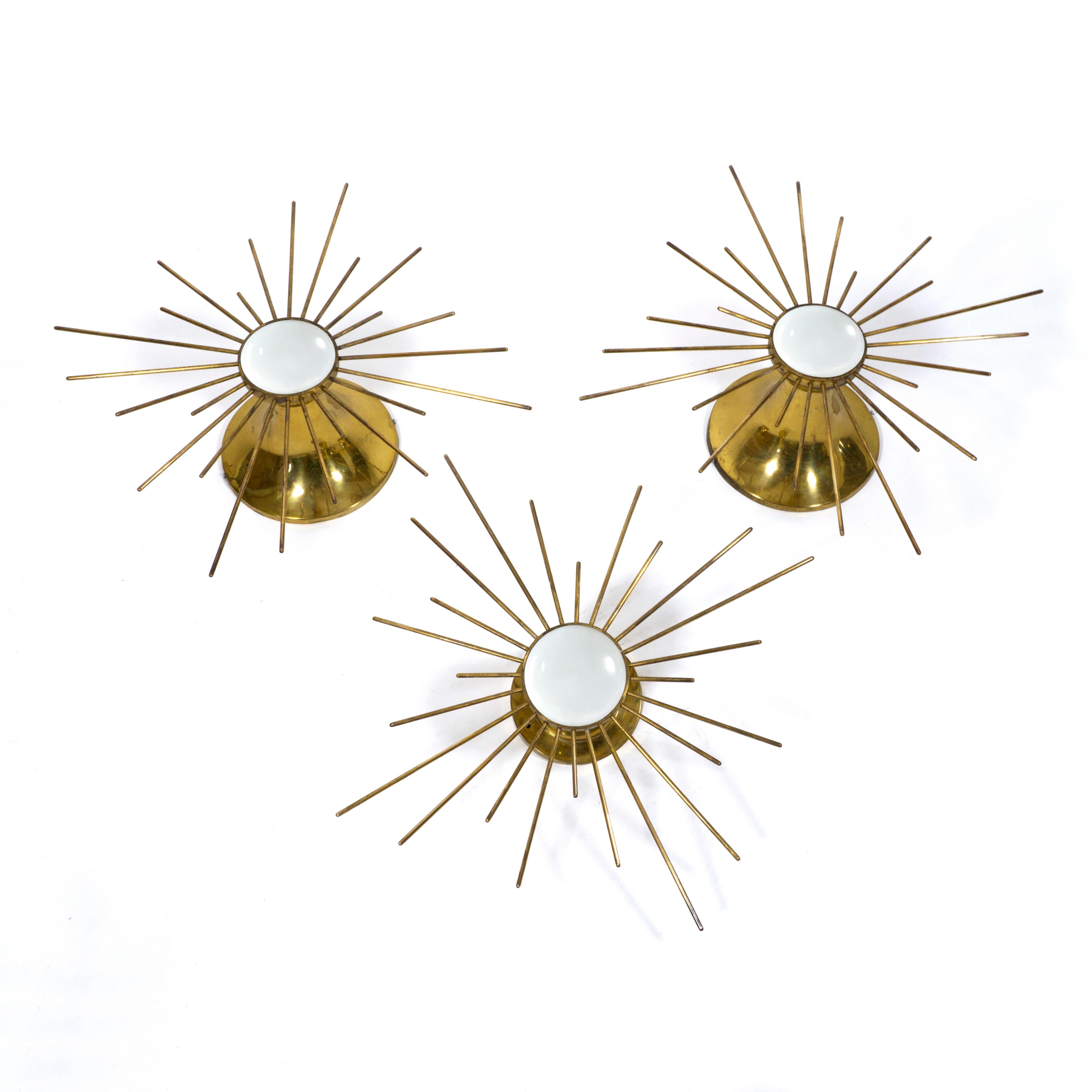 Beautiful set consisting of 3 large Sunburst wall or ceiling lamps  sconces from the 1960s. These stunning lamps are both lighting and sculpture. They used to hang in a bavarian church.
Very beautiful design with high quality finish. E27 socket.