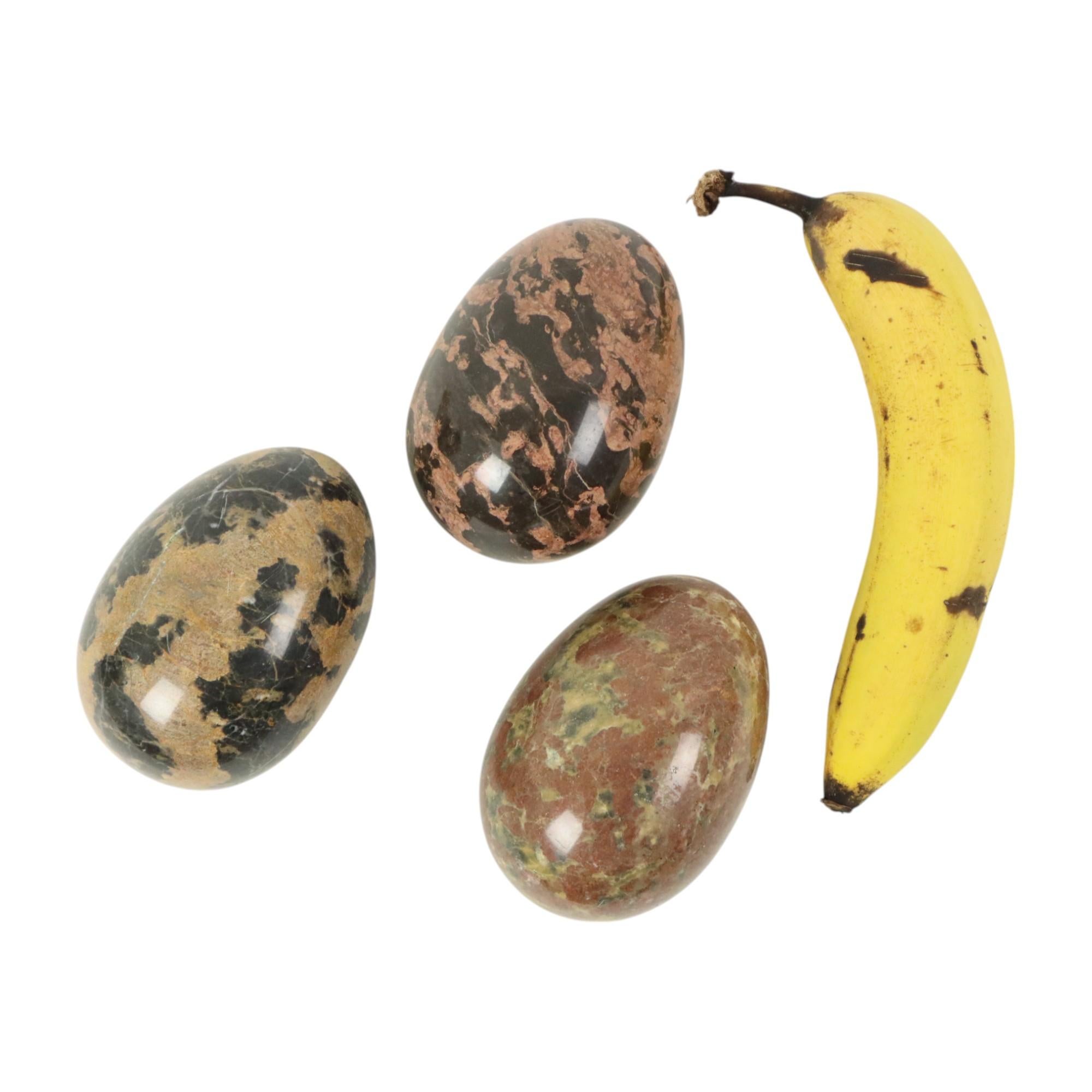 Nice set of 3 large eggs, made of solid marble or natural stone, circa second half of the 20th century, banana for scale.

These exceptionally large eggs are smoothly polished and very high-quality and decorative, the natural lines and patterns from