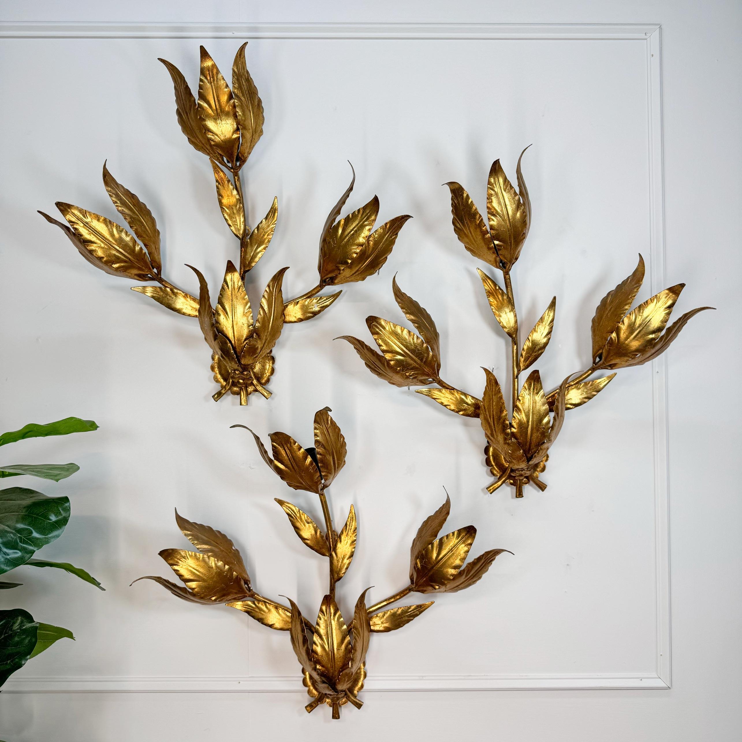 A superb set of 3 Hans Kogl wall lights from the 1970's, formed as branches and leaves and decorated with gold leaf gilt finish.



Each wall light houses 3 e14 (small screw in) lamp holders.



Fully Rewired and PAT tested.



Price is for the set