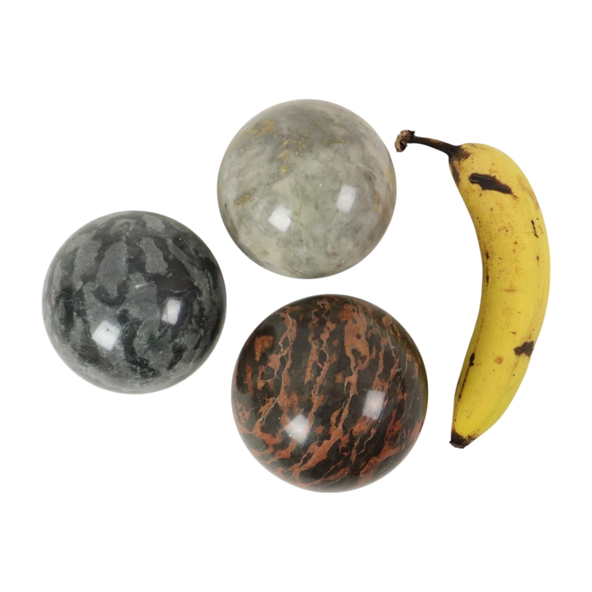 Set of 3 large decorative polished balls, balls made of solid marble or natural stone, colorful gemstones with different color shades, second half of the 20th century, banana for scale.

These exceptionally large balls are smoothly polished and very