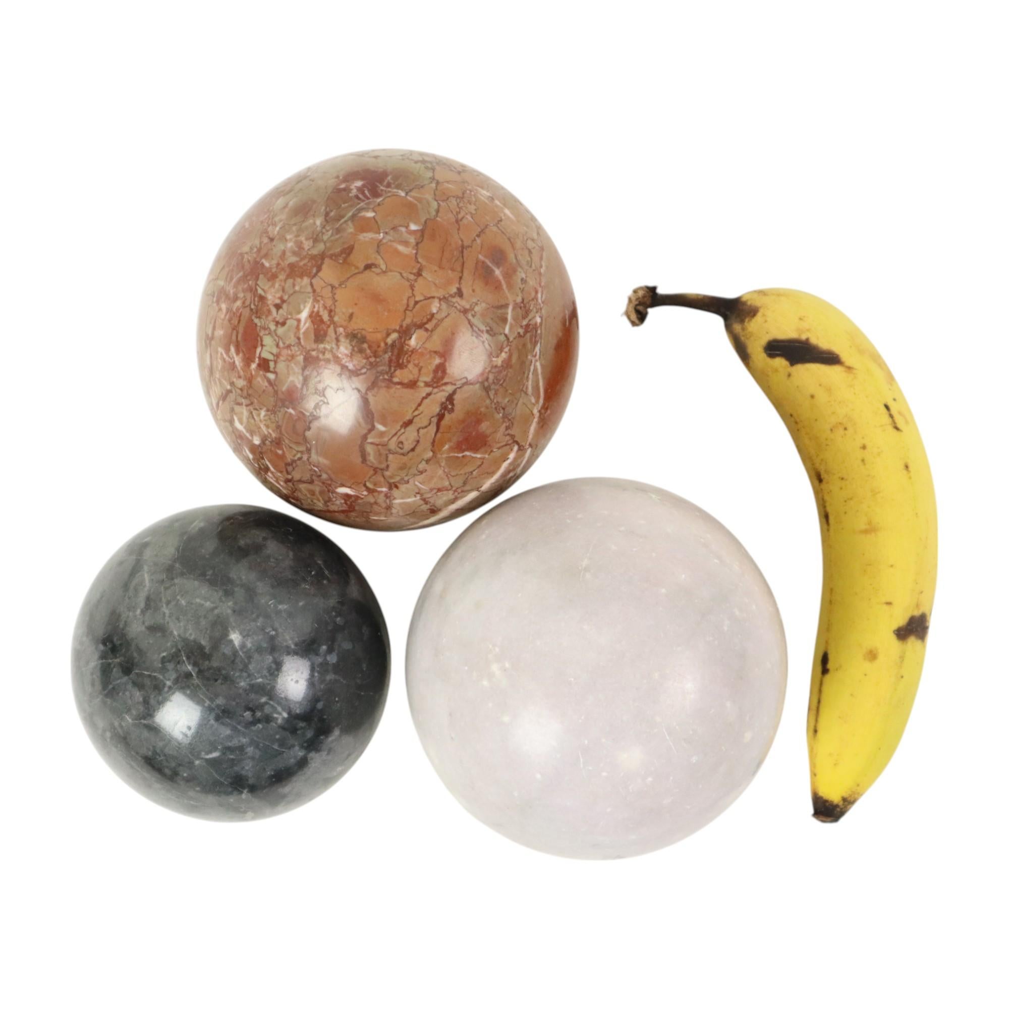 Set of 3 large decorative polished balls, balls made of solid marble or natural stone, colorful gemstones with different color shades, second half of the 20th century, banana for scale.

These exceptionally large balls are smoothly polished and very