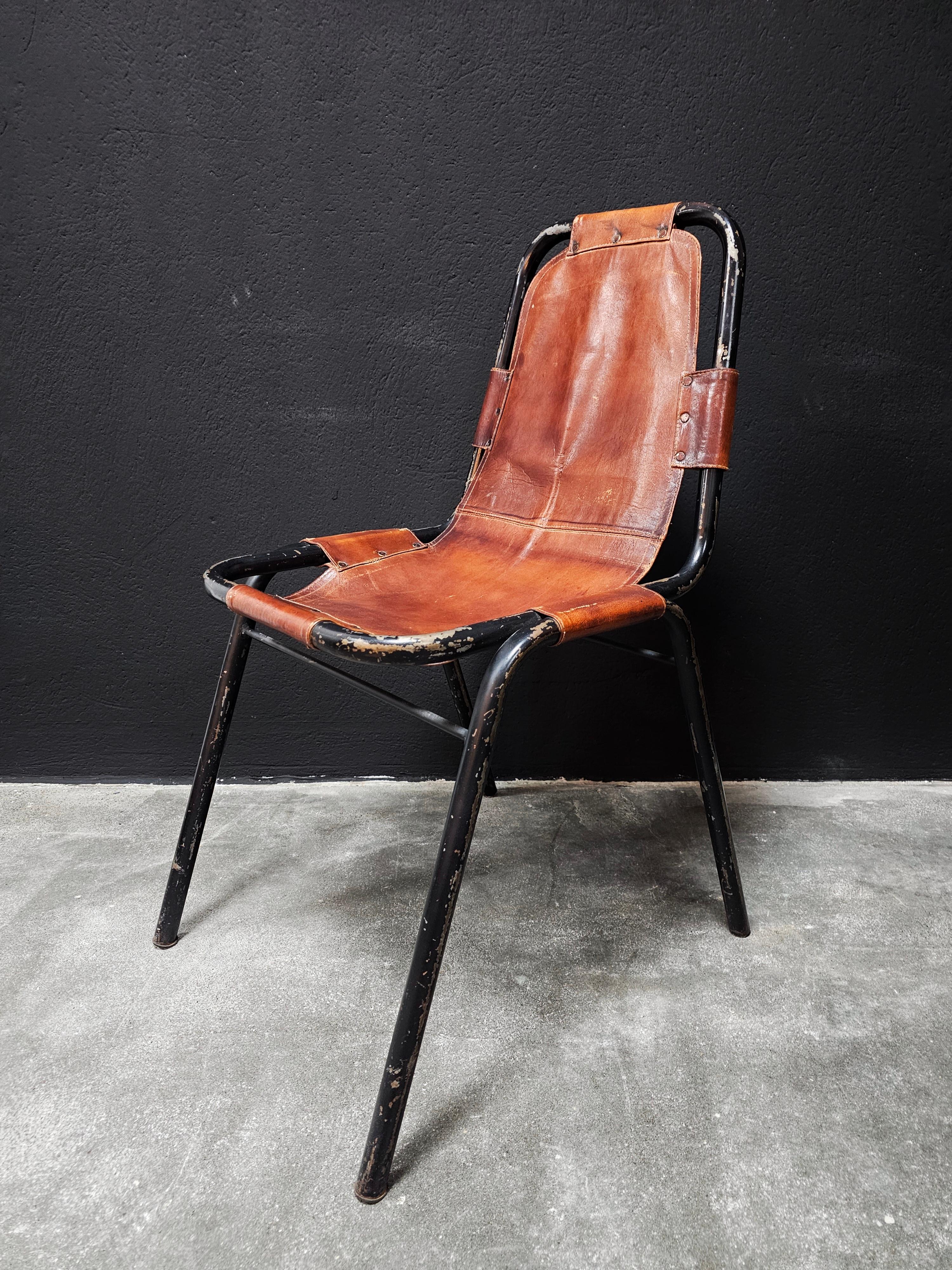 In this listing you will find three Bauhaus Leather Dining Chairs designed and manufactured by DalVera in the style of Charlotte Perriand. The chairs feature black tubular frame and cognac leather seats. the black frames indicate that this is the