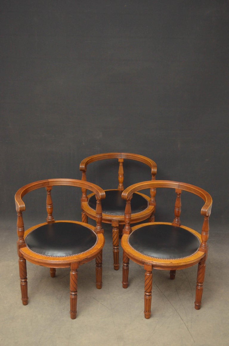 Sn5166 Fine quality and very unusual set of 3, early Victorian oak and walnut desk chairs, each having curved reeded back rail, three turned and reeded supports and circular leather upholstered closely studded seat, standing on decorative carved