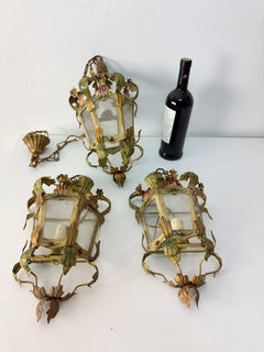 Set of 3 lights (2 wall lamps and 1 small chandelier) in decorated wrought iron