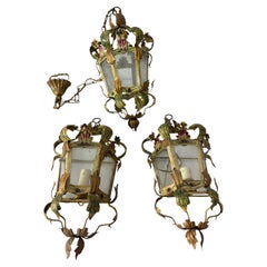 Set of 3 lights (2 wall lamps and 1 small chandelier) in decorated wrought iron