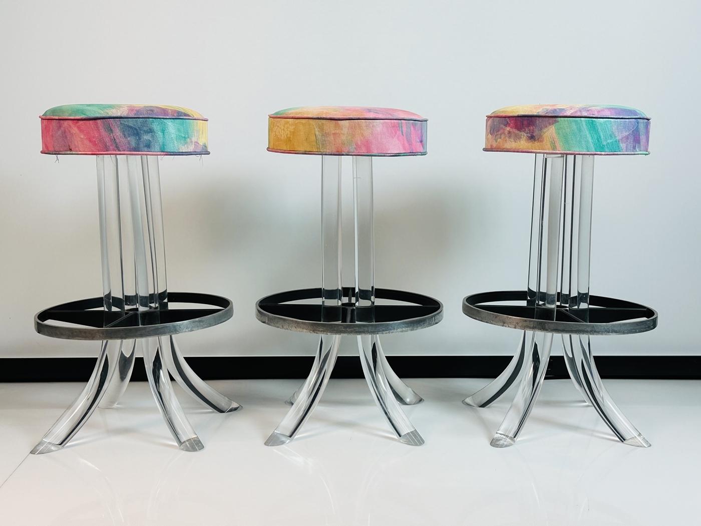 Vintage Lucite and metal tusk barstools with a swivel seat designed and manufactured in the United States in the early 1960s in the style of Charles Hollis Jones.
 
 The stools have a beautifully sculpted TUSK Lucite base having blackened round